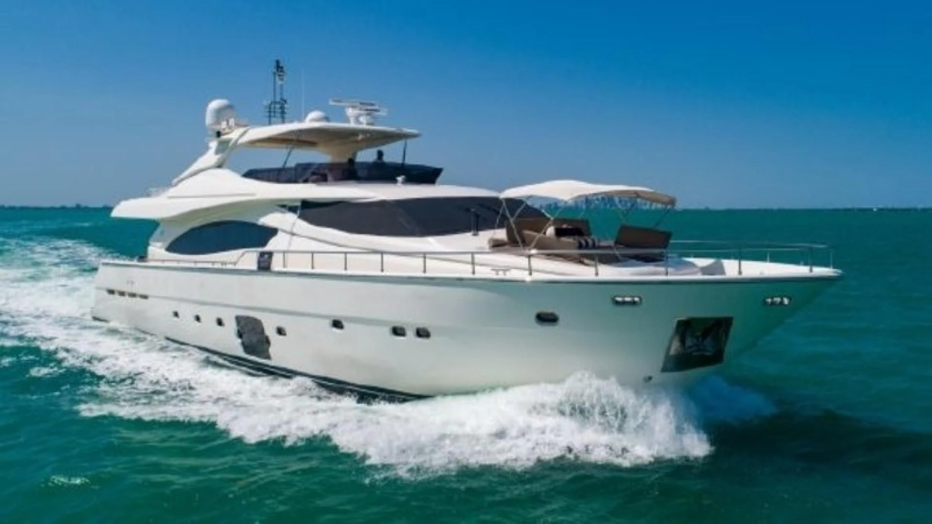 a white yacht on the water aboard INDULGE II Yacht for Sale