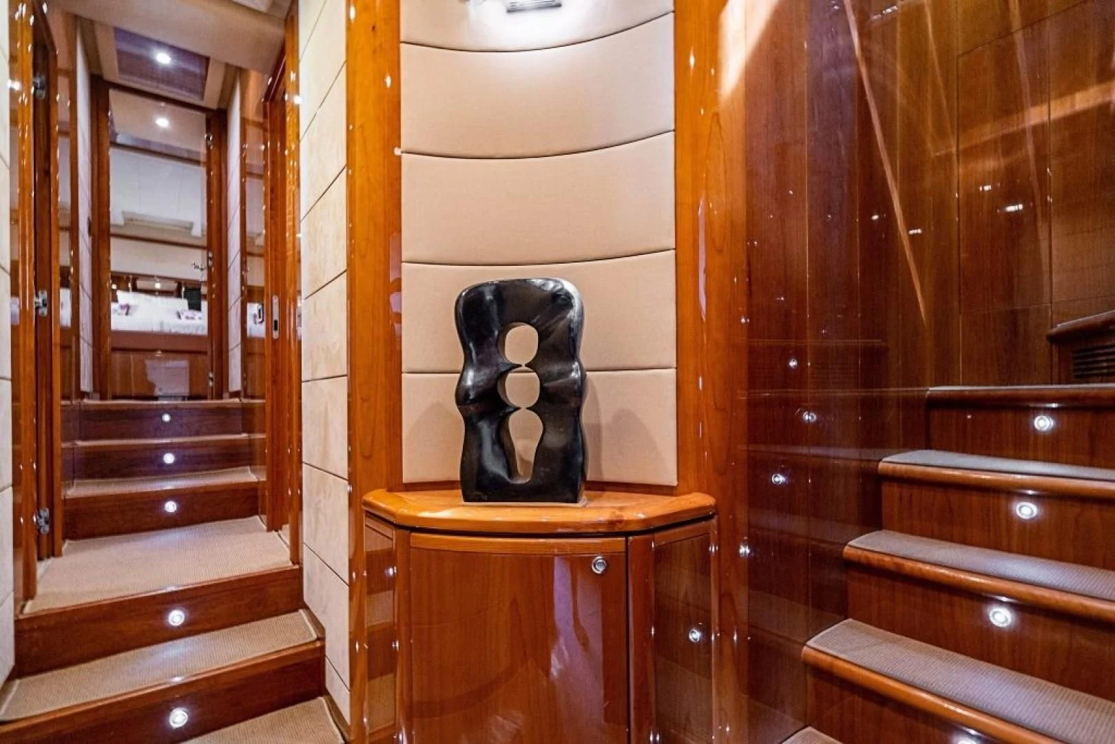 a pair of black boots on a wooden stool aboard INDULGE II Yacht for Sale