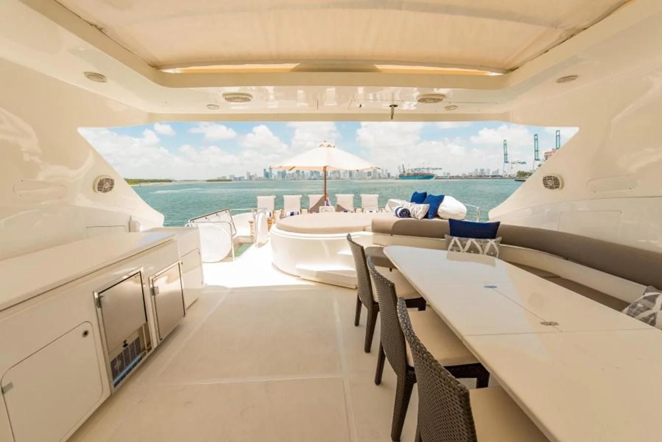 a room with a table chairs and a pool aboard INDULGE II Yacht for Sale
