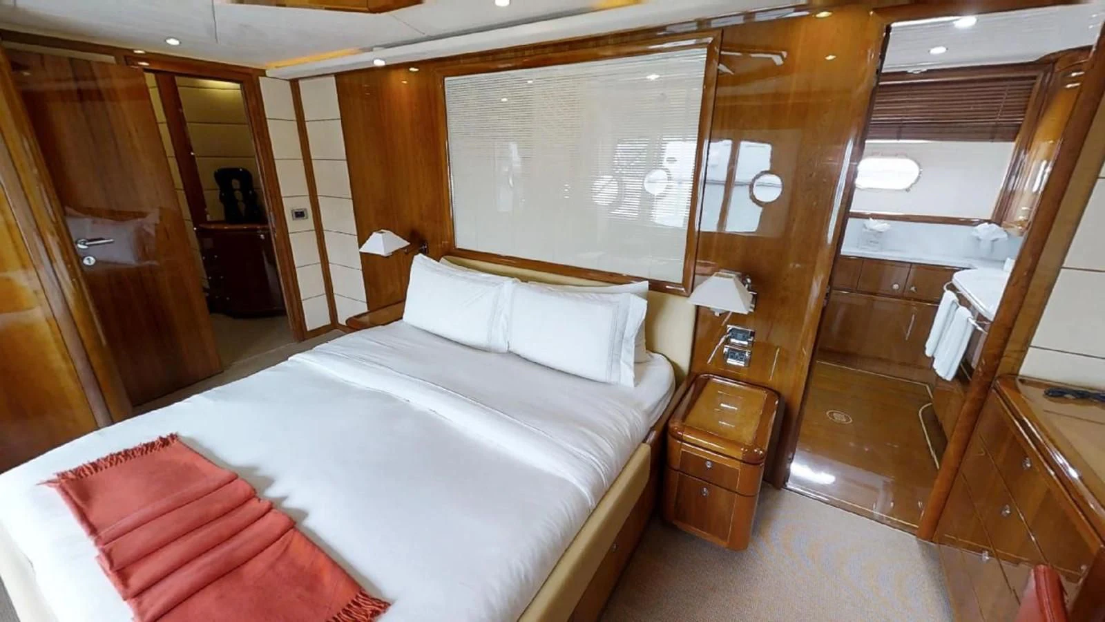 a room with a bed and a mirror aboard INDULGE II Yacht for Sale