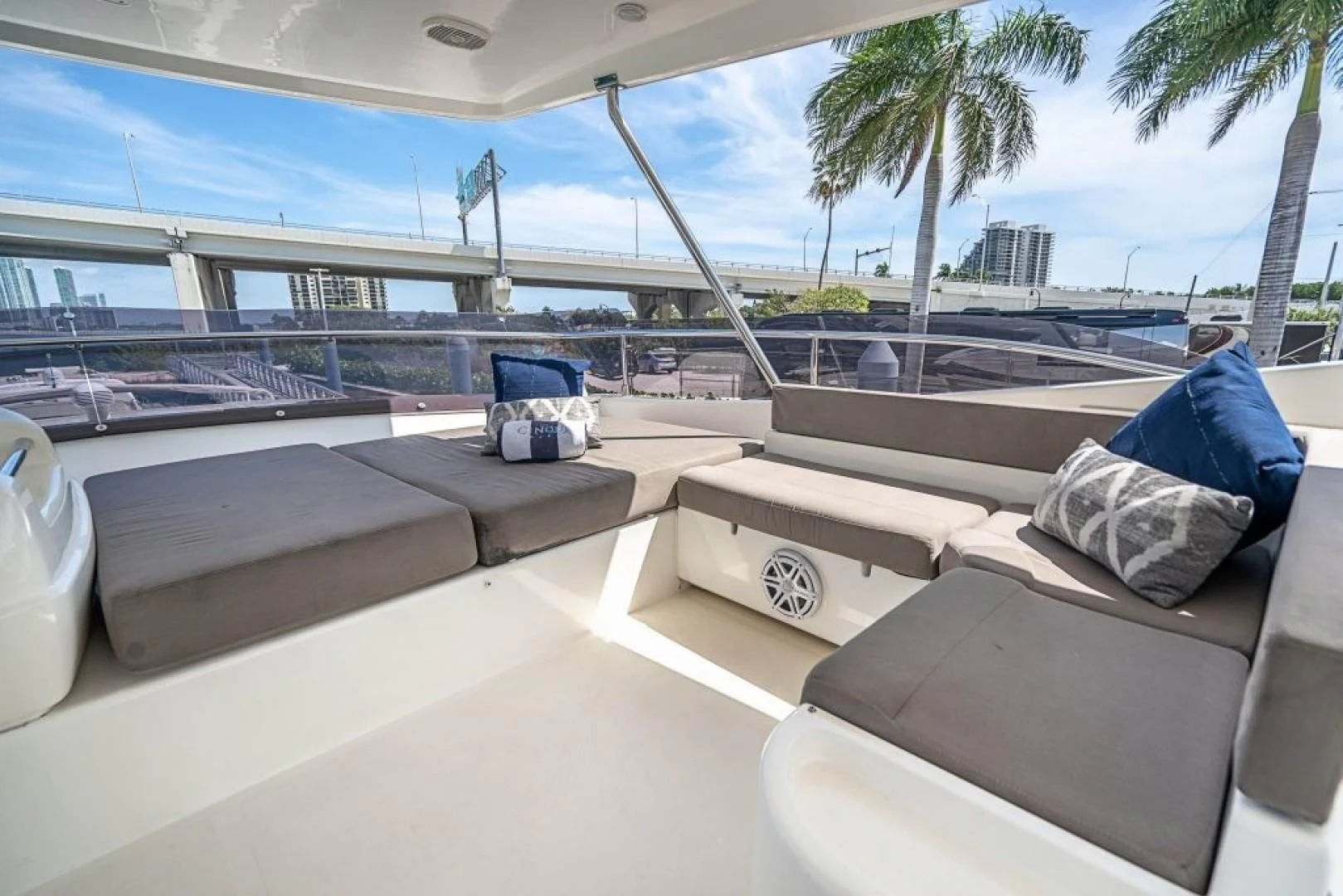 a deck with a pool and lounge chairs aboard INDULGE II Yacht for Sale