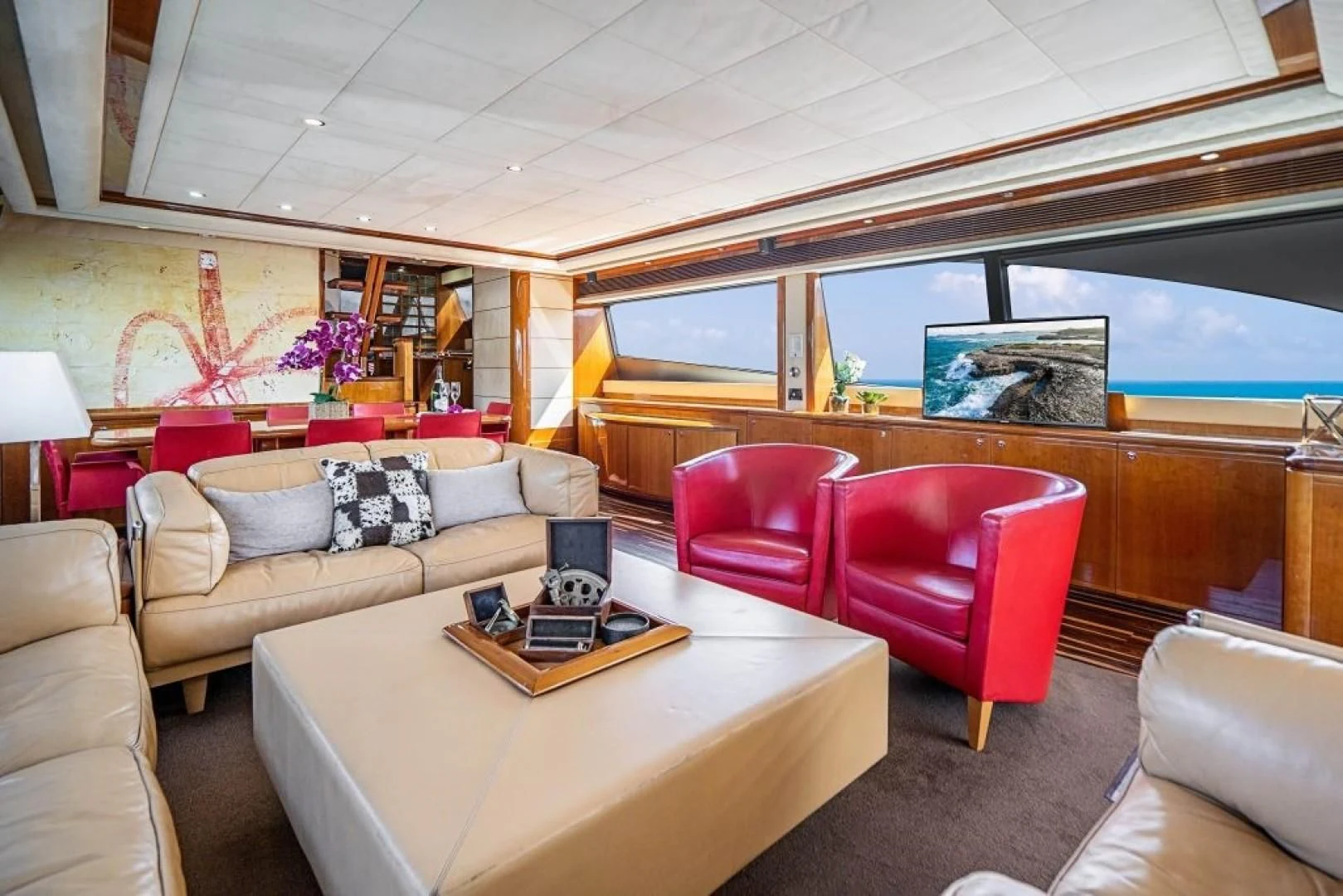 a living room with a couch and a table aboard INDULGE II Yacht for Sale