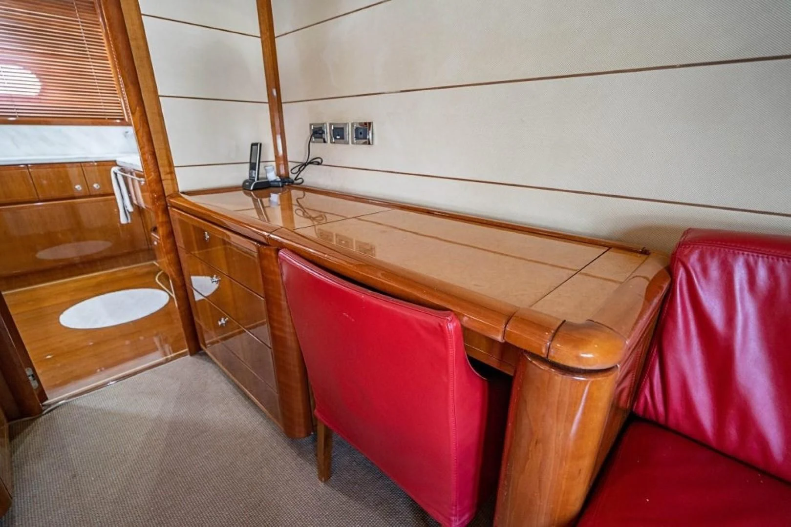 a red chair in a room aboard INDULGE II Yacht for Sale