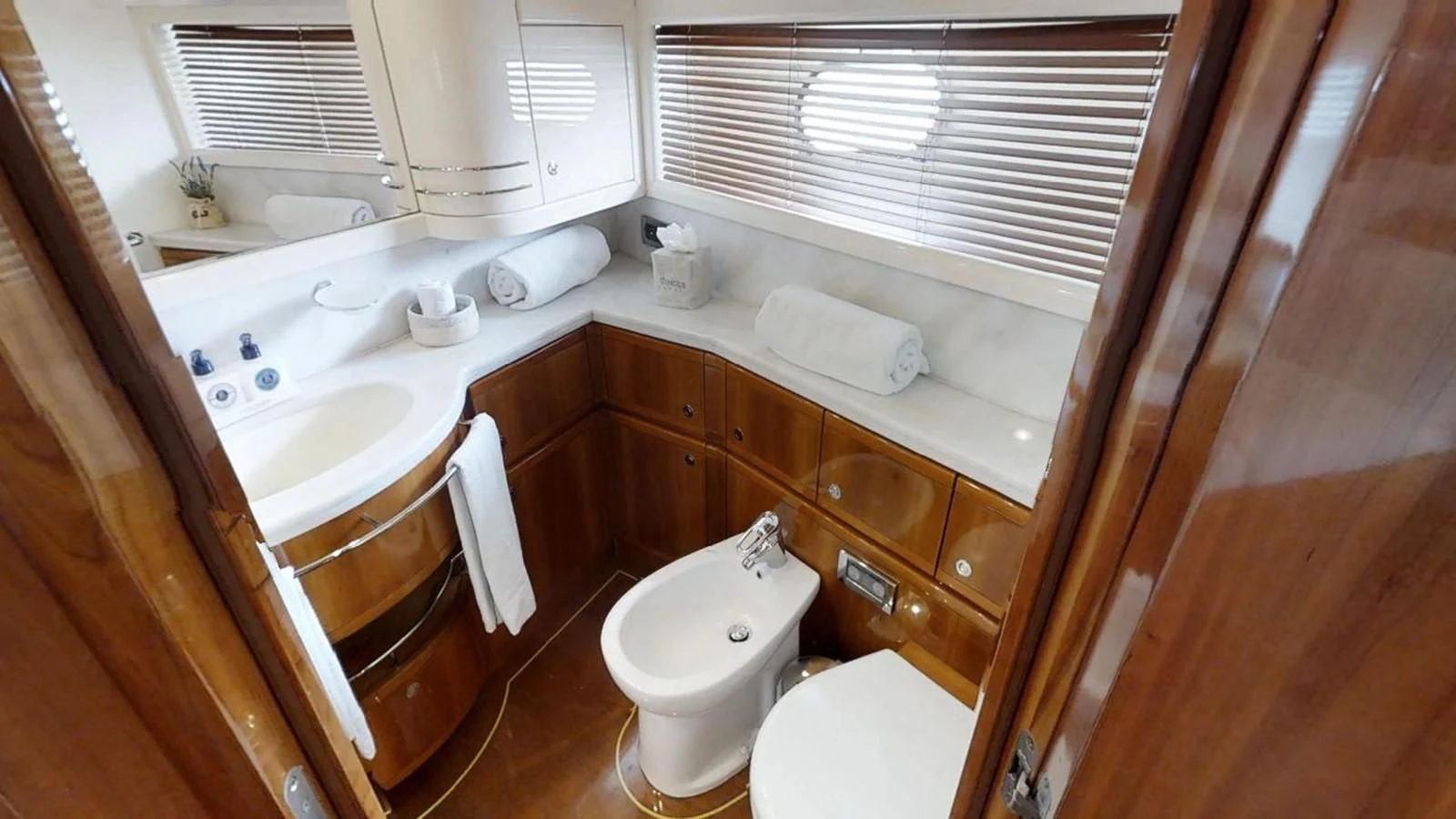 a bathroom with a sink and a toilet aboard INDULGE II Yacht for Sale