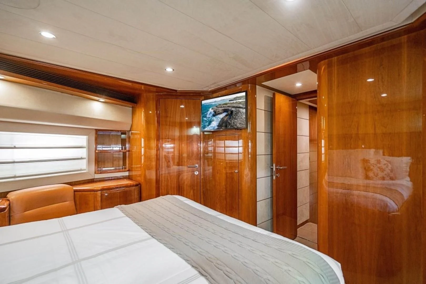 a room with a bed and a chair aboard INDULGE II Yacht for Sale