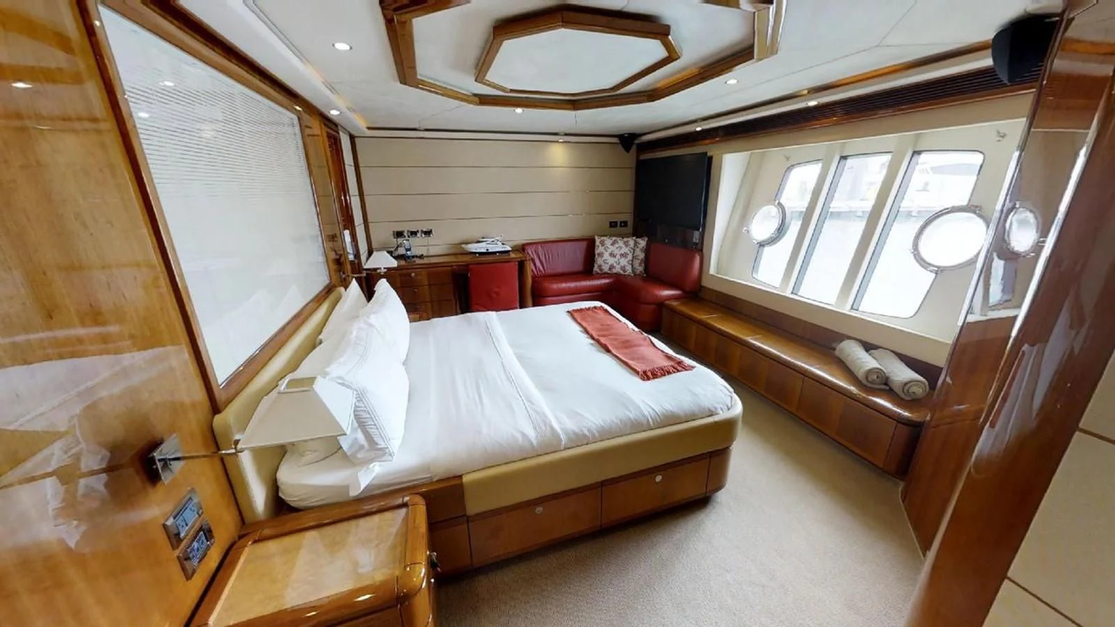 a room with a bed and a window aboard INDULGE II Yacht for Sale