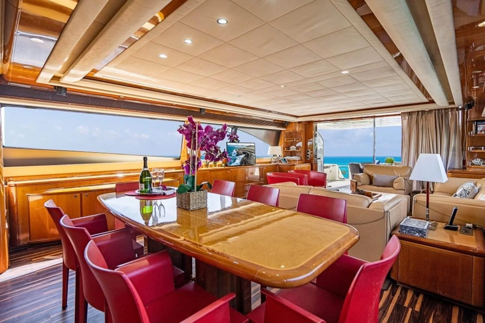 a room with a table and chairs aboard INDULGE II Yacht for Sale