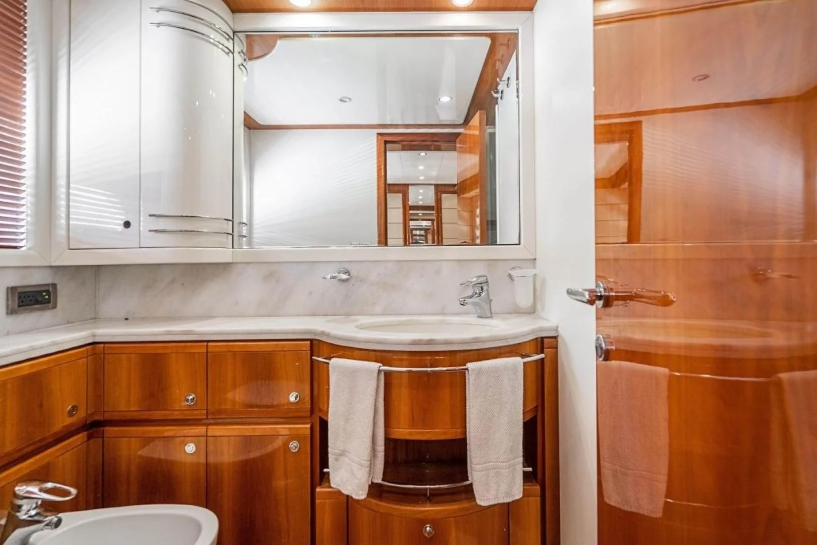 a kitchen with wooden cabinets aboard INDULGE II Yacht for Sale