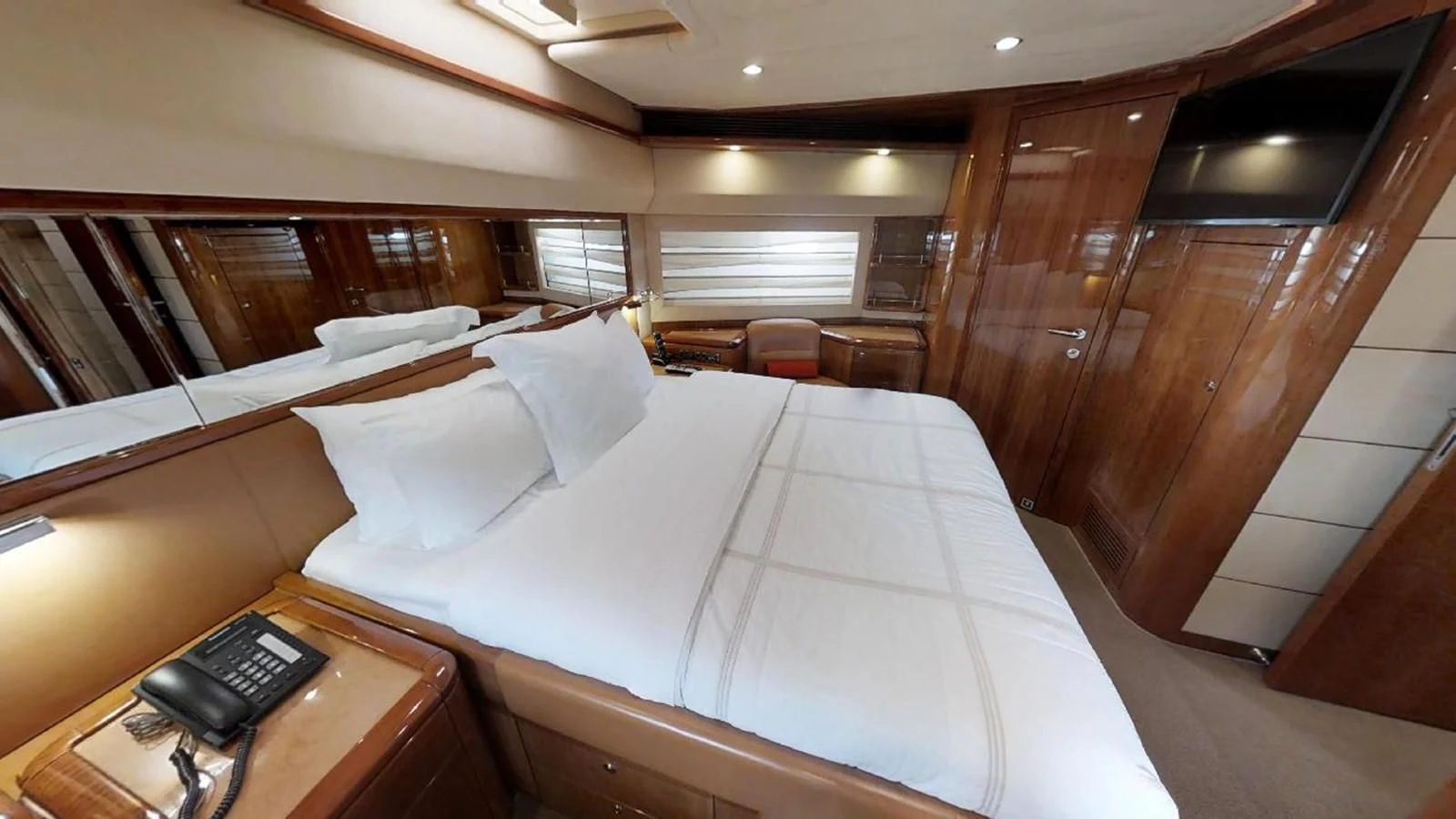 a room with a bed and a desk aboard INDULGE II Yacht for Sale