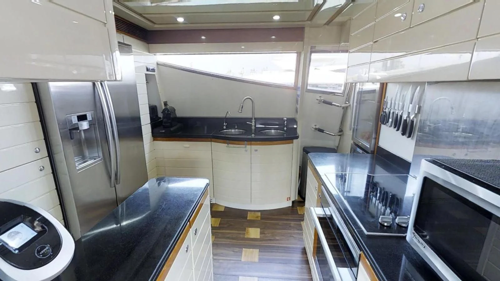 a kitchen with a sink and a microwave aboard INDULGE II Yacht for Sale