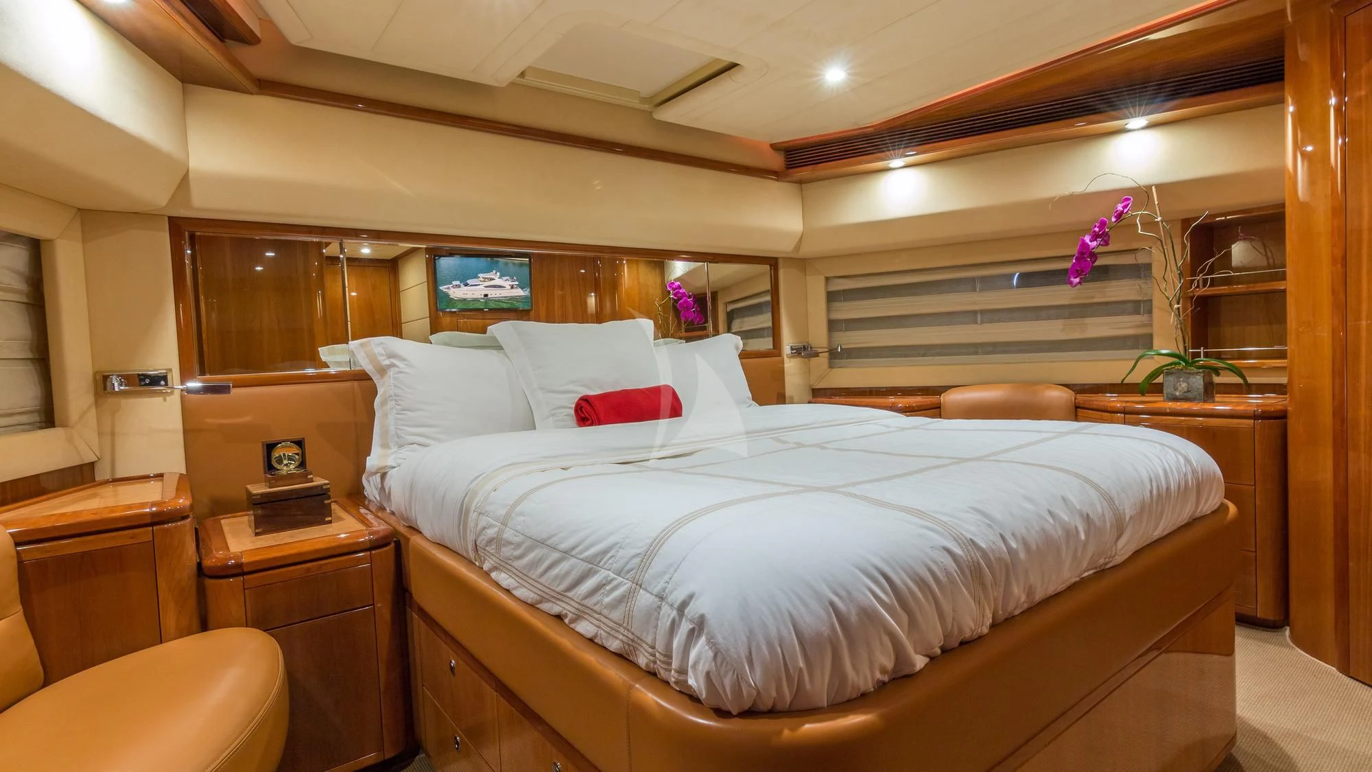 a bed with white sheets and pillows aboard INDULGE II Yacht for Sale