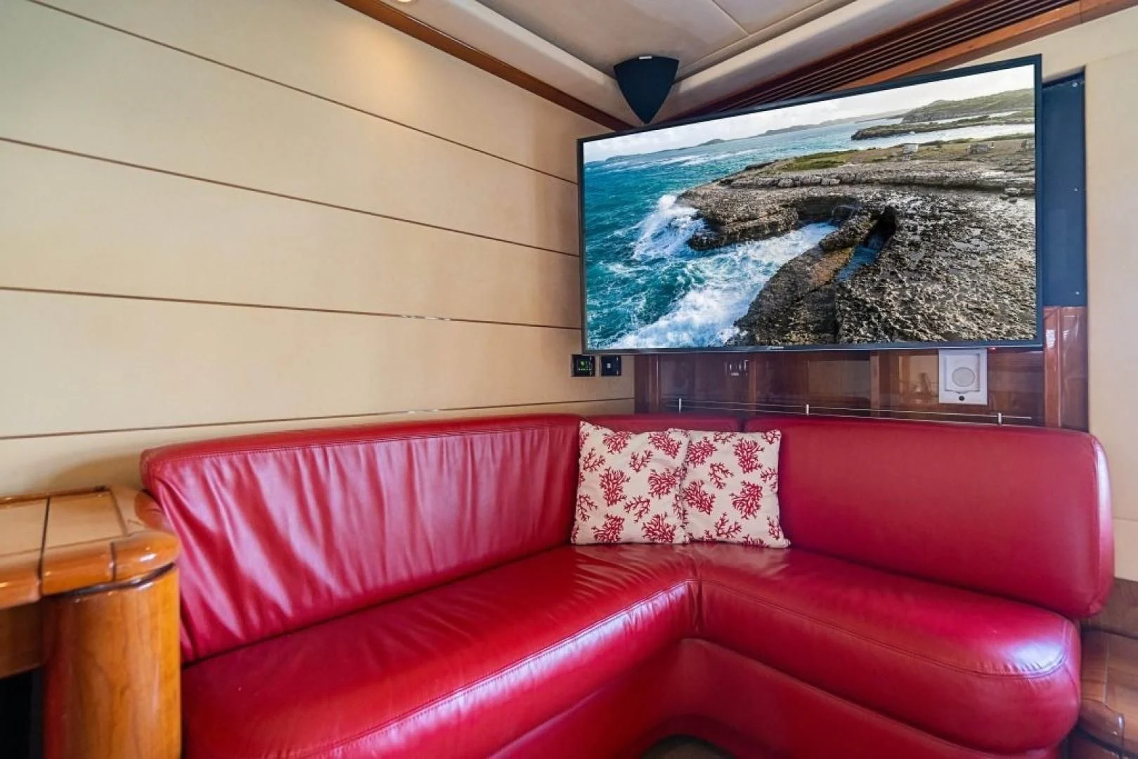 a couch with a painting on the wall aboard INDULGE II Yacht for Sale