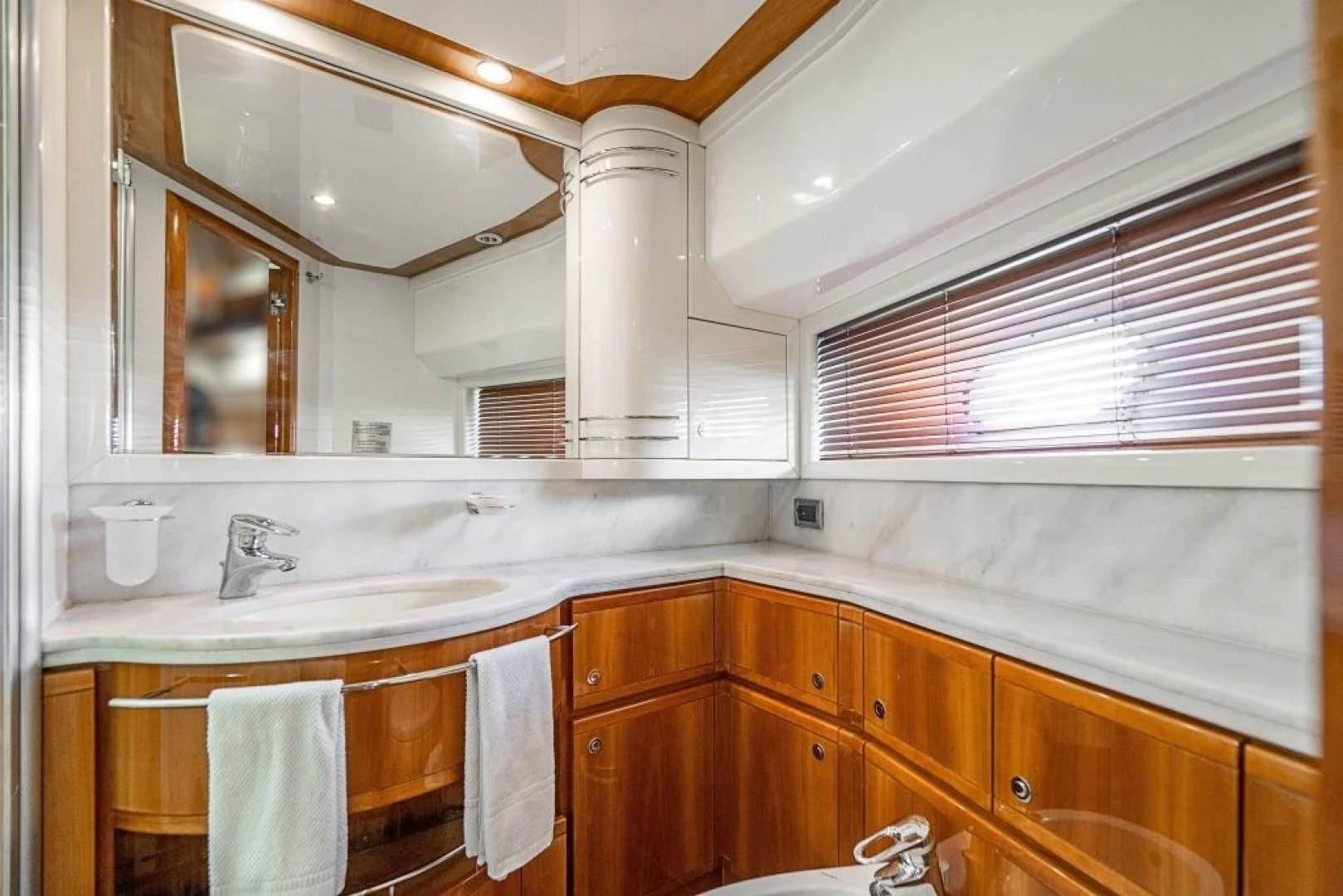 a kitchen with wooden cabinets aboard INDULGE II Yacht for Sale
