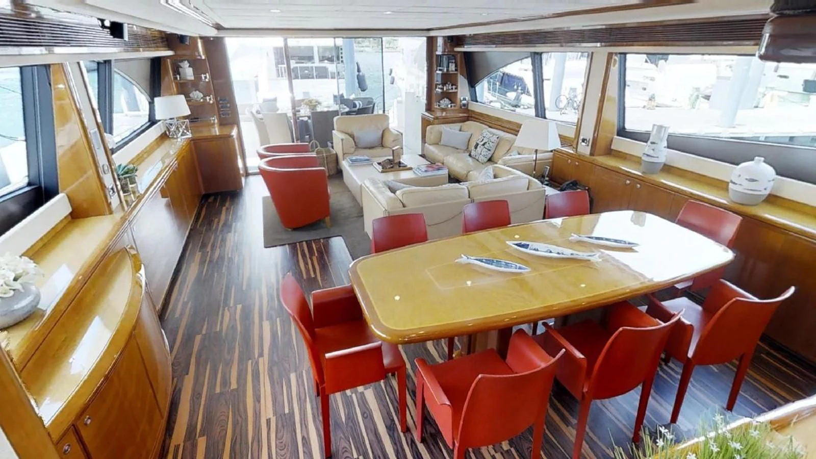 a room with tables and chairs aboard INDULGE II Yacht for Sale