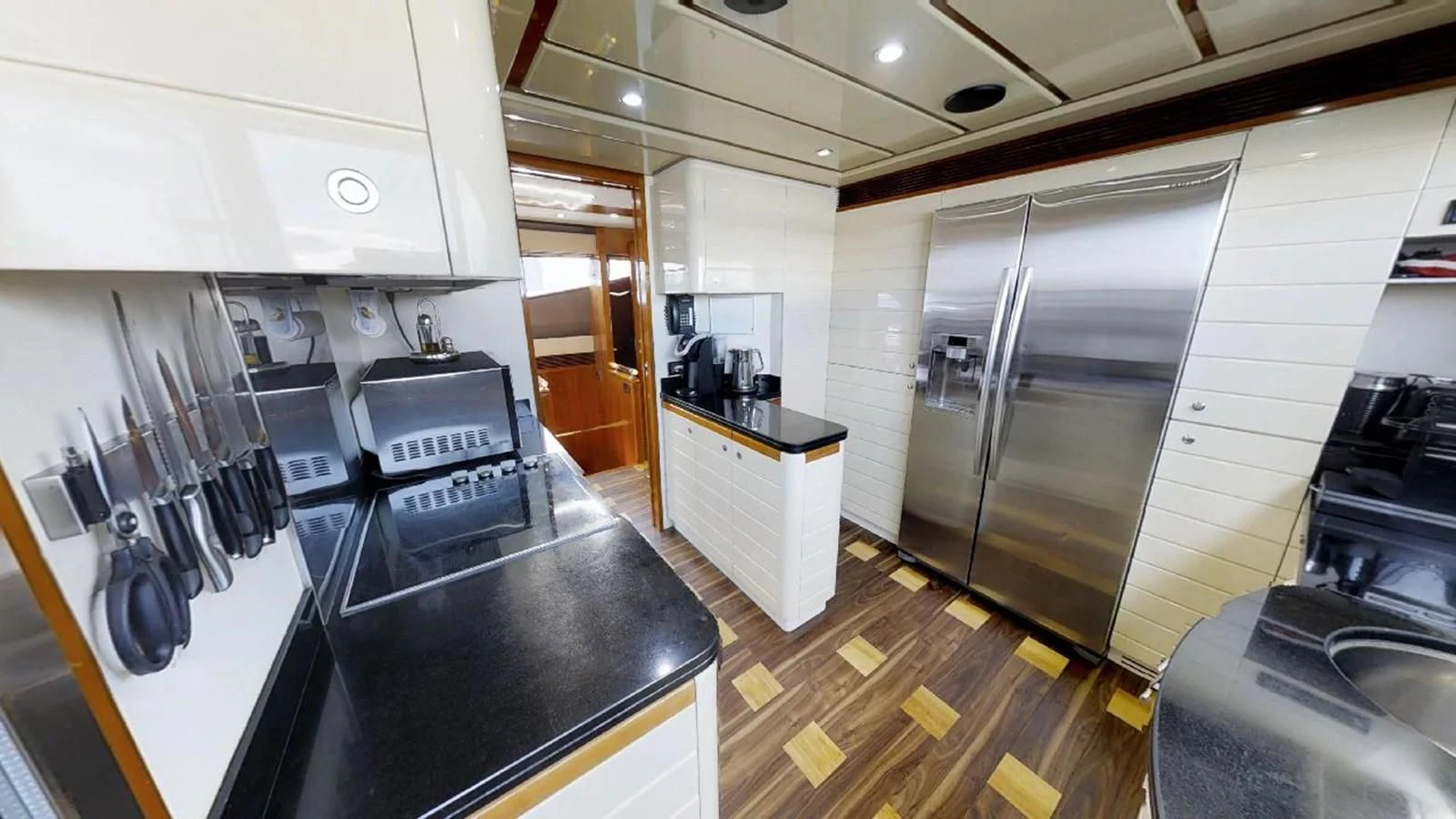 a kitchen with stainless steel appliances aboard INDULGE II Yacht for Sale