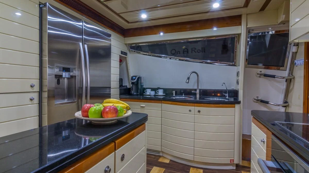 a kitchen with white cabinets aboard INDULGE II Yacht for Sale