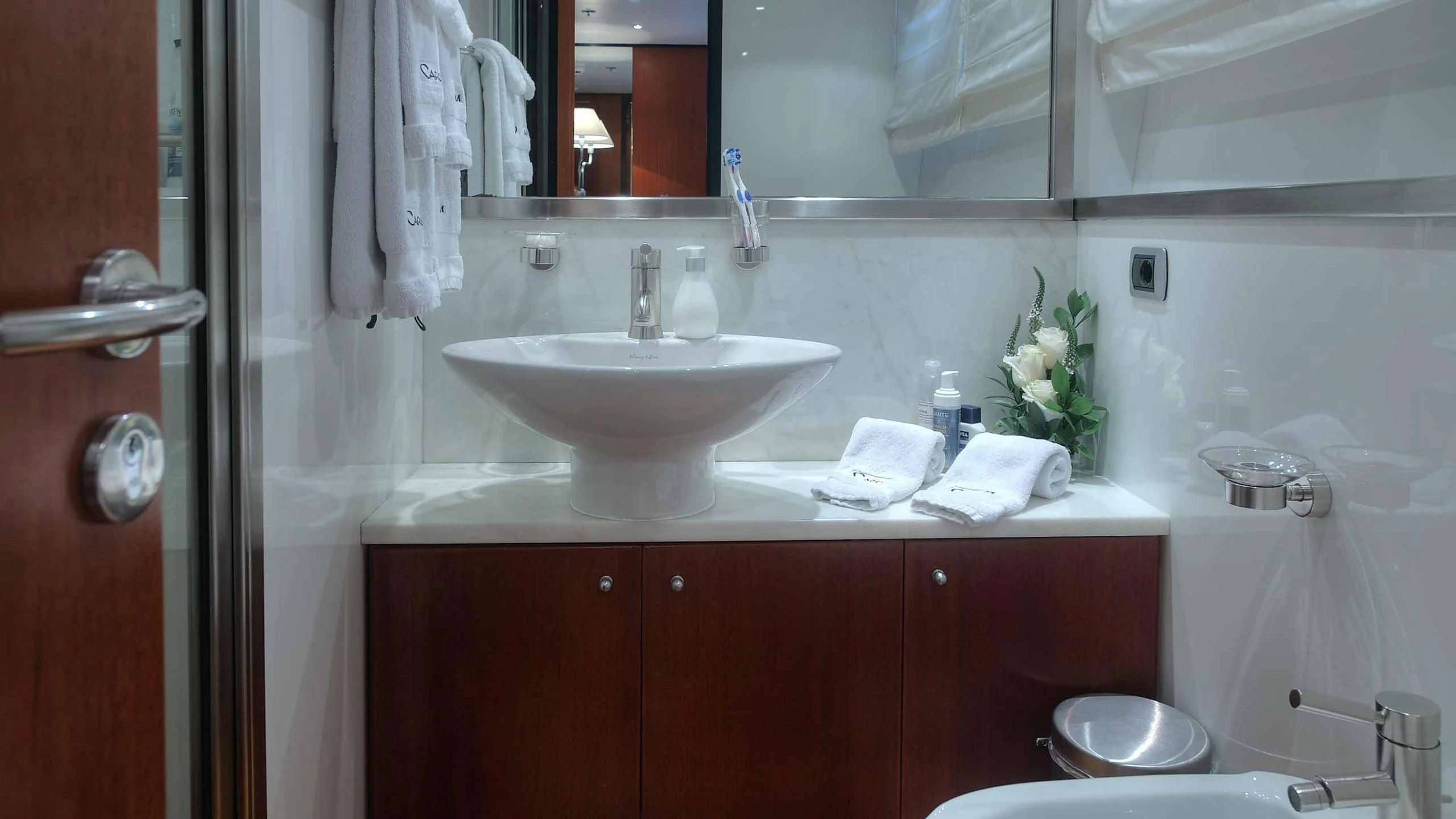a bathroom with a sink and a mirror aboard CAROM Yacht for Sale