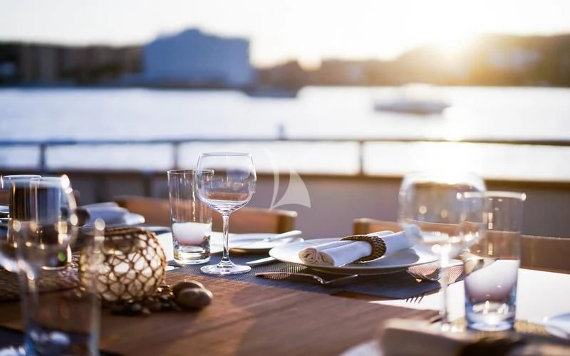 a table with glasses and food on it aboard CAROM Yacht for Sale