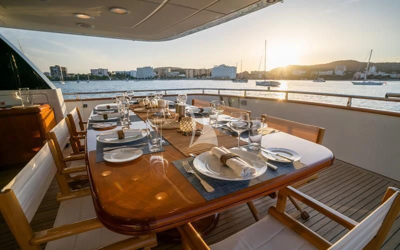 a table with plates and glasses on it aboard CAROM Yacht for Sale