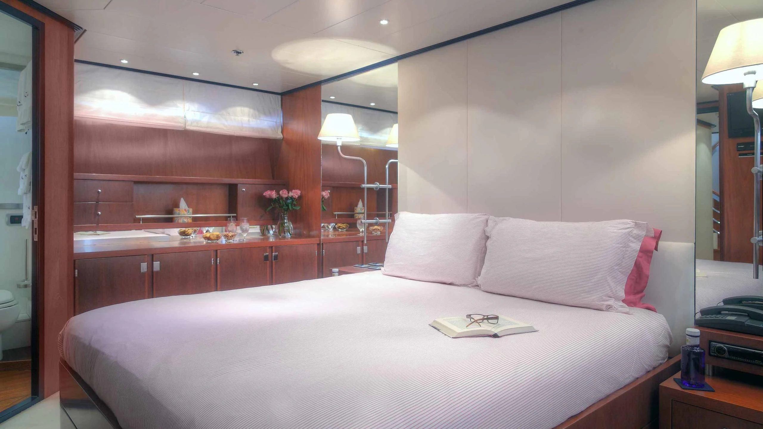 a bed with white sheets and pillows aboard CAROM Yacht for Sale