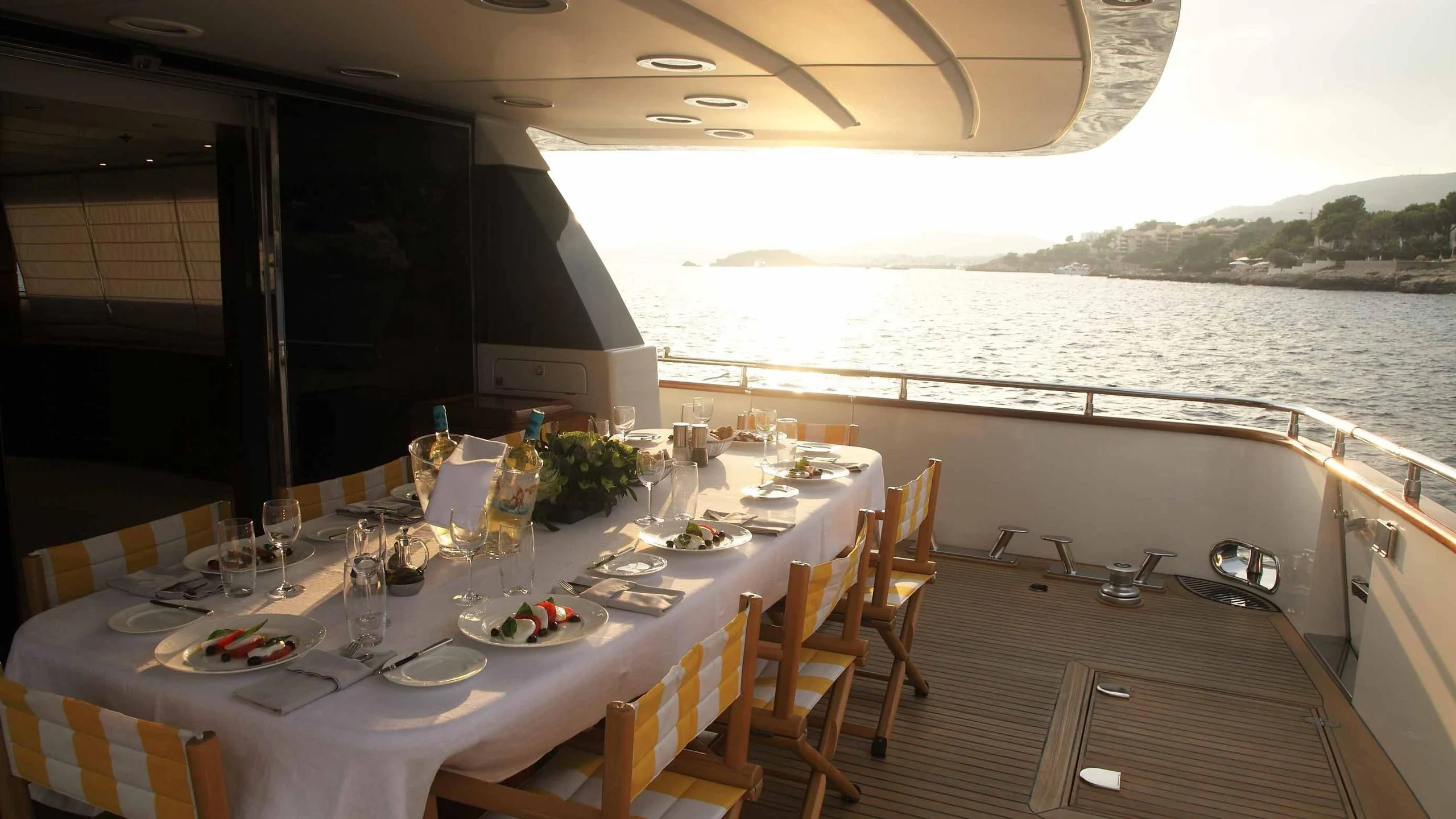 a table set for a meal on a boat aboard CAROM Yacht for Sale