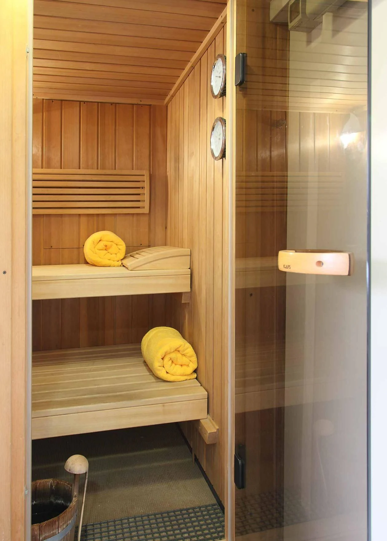 a wood closet with a clock and a shelf with objects on it aboard CAROM Yacht for Sale