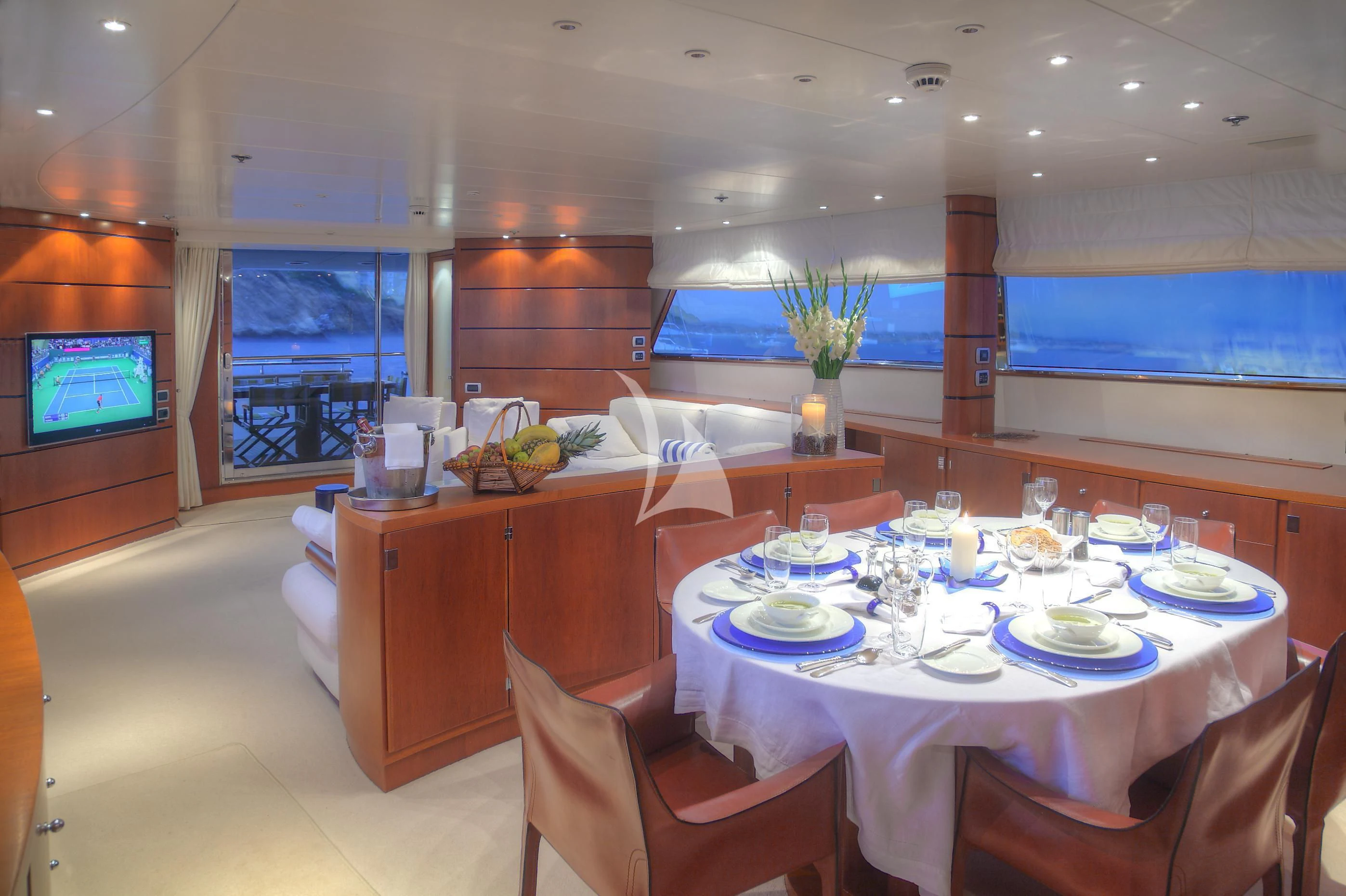 a dining room with a table set aboard CAROM Yacht for Sale