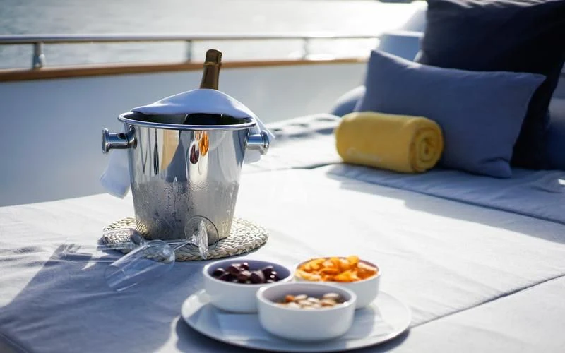 a table with bowls of food aboard CAROM Yacht for Sale