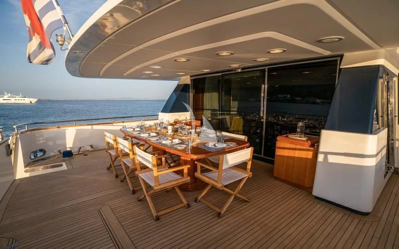 a room with a table and chairs aboard CAROM Yacht for Sale