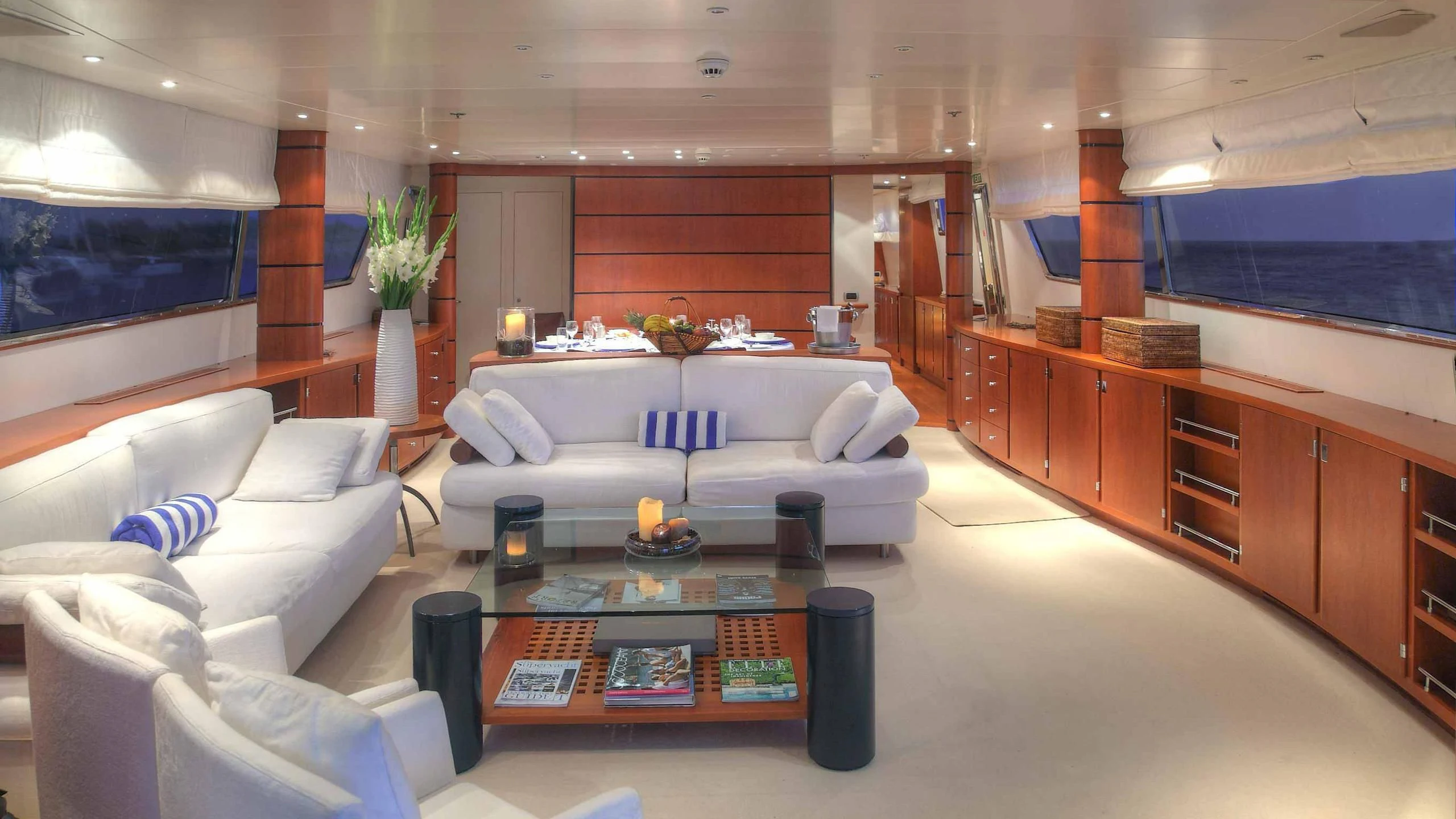 a living room with a couch and a coffee table aboard CAROM Yacht for Sale