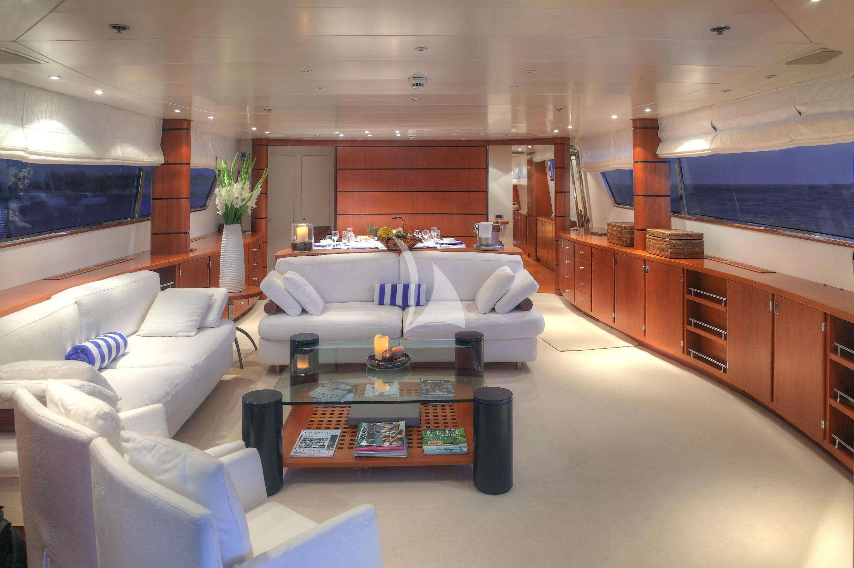 a living room with a white couch and a coffee table aboard CAROM Yacht for Sale