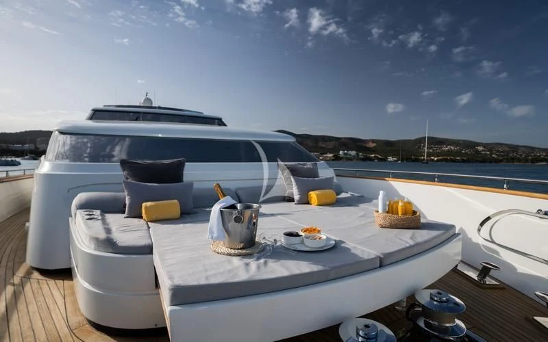 a table with a plate of food and a grill on it aboard CAROM Yacht for Sale