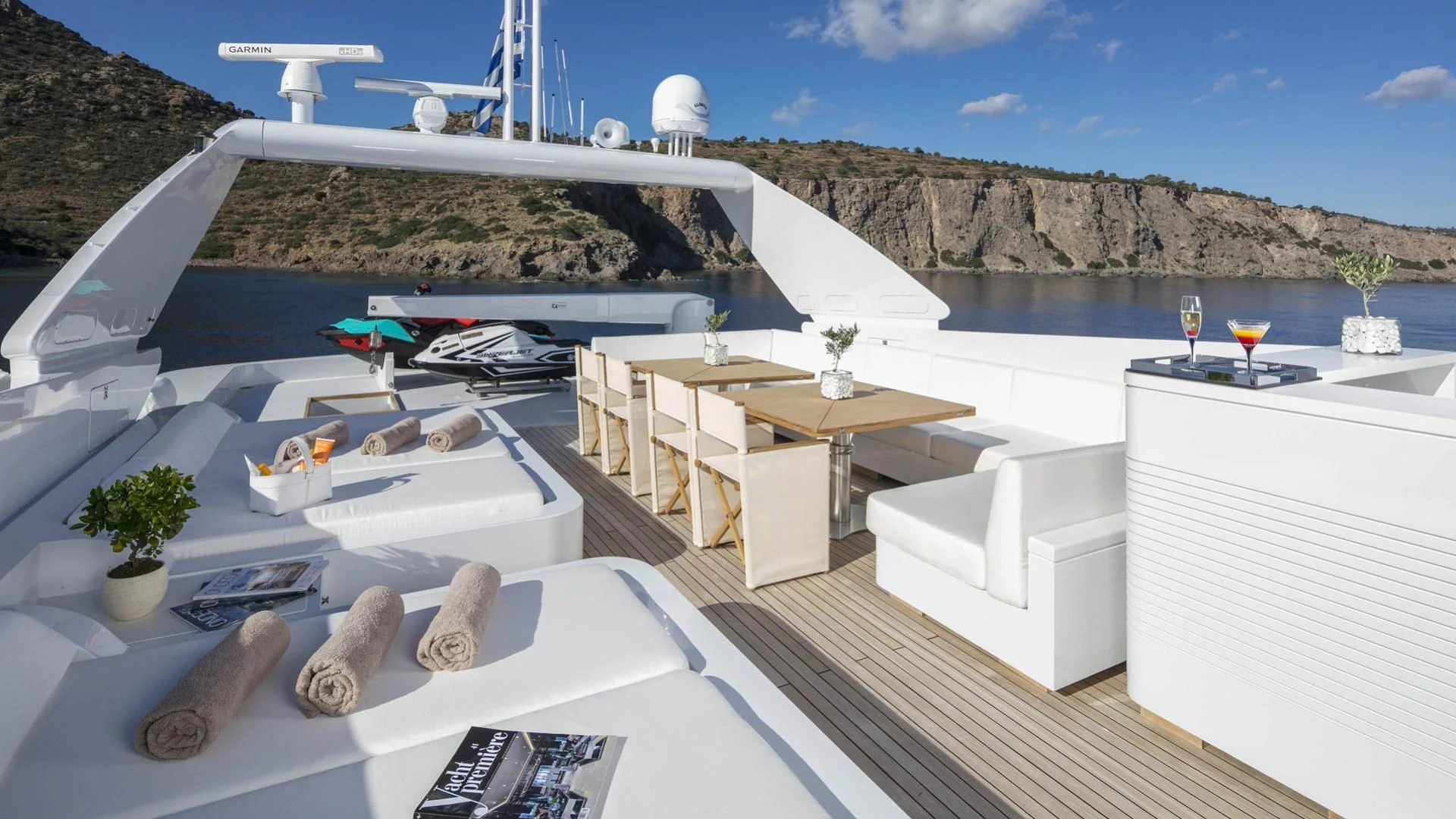 a room with a pool and a deck with a view of a mountain and water aboard SOLE DI MARE Yacht for Sale