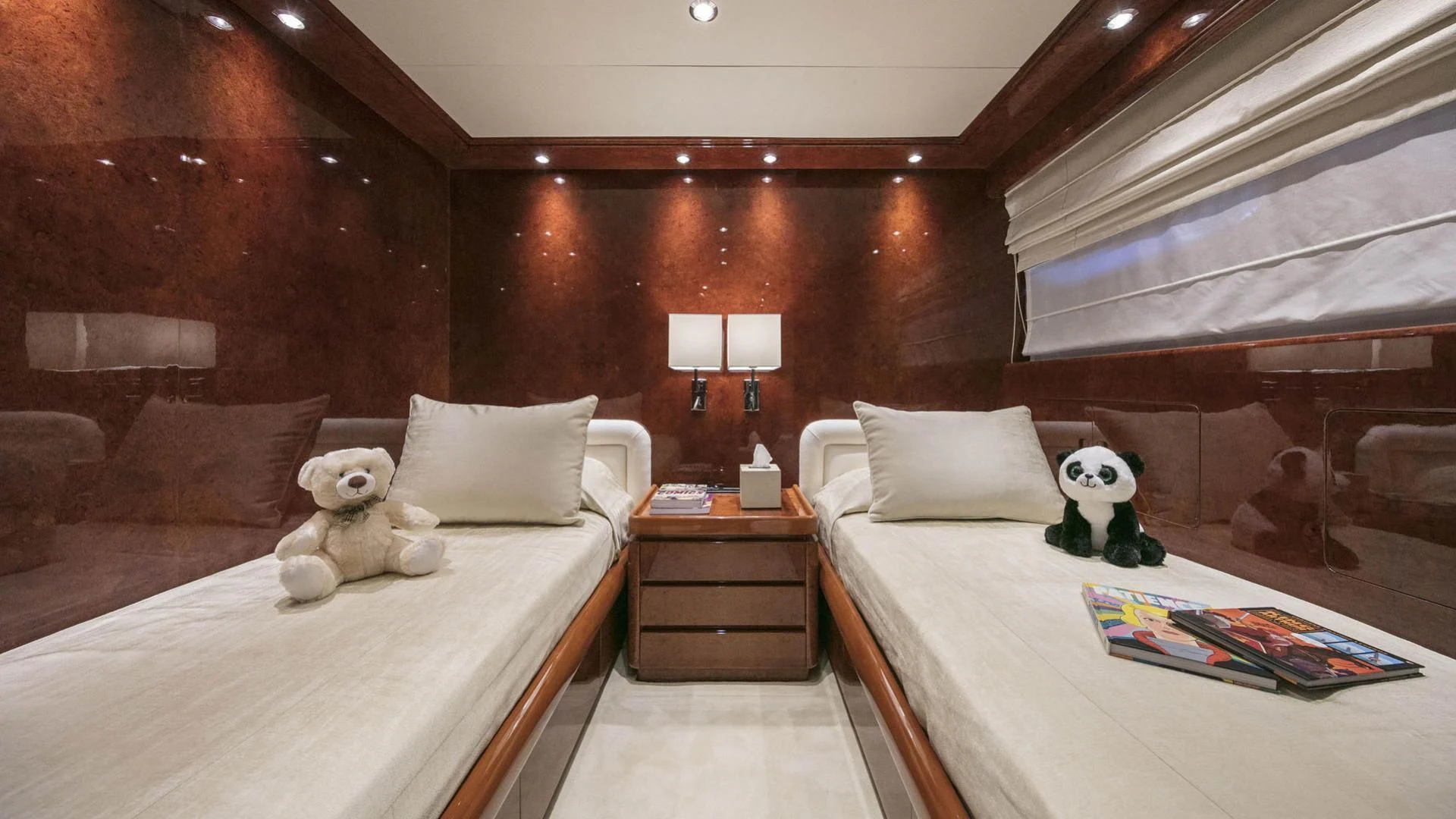 a room with a bed and a teddy bear aboard SOLE DI MARE Yacht for Sale