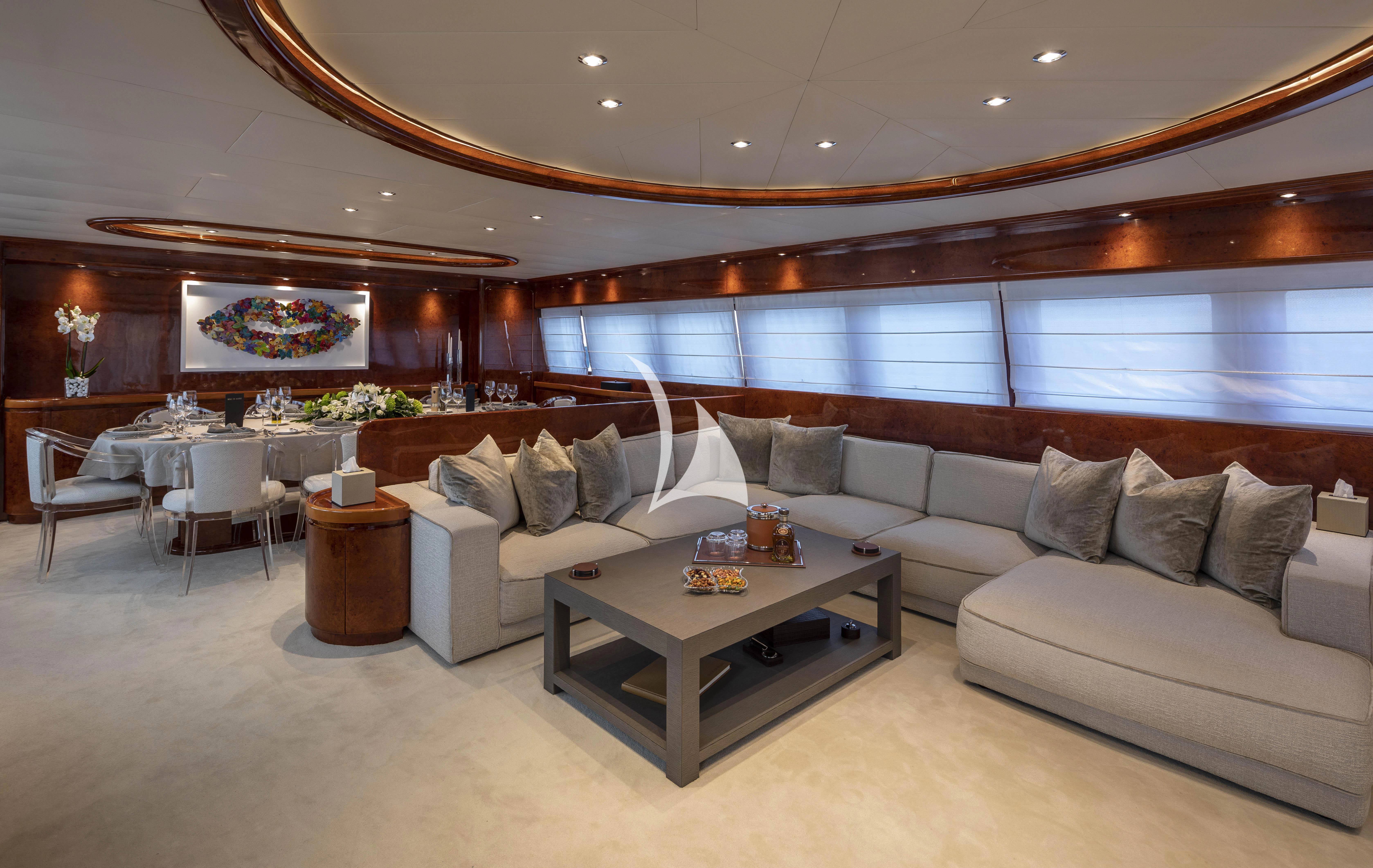 a living room with a couch and a coffee table aboard SOLE DI MARE Yacht for Sale