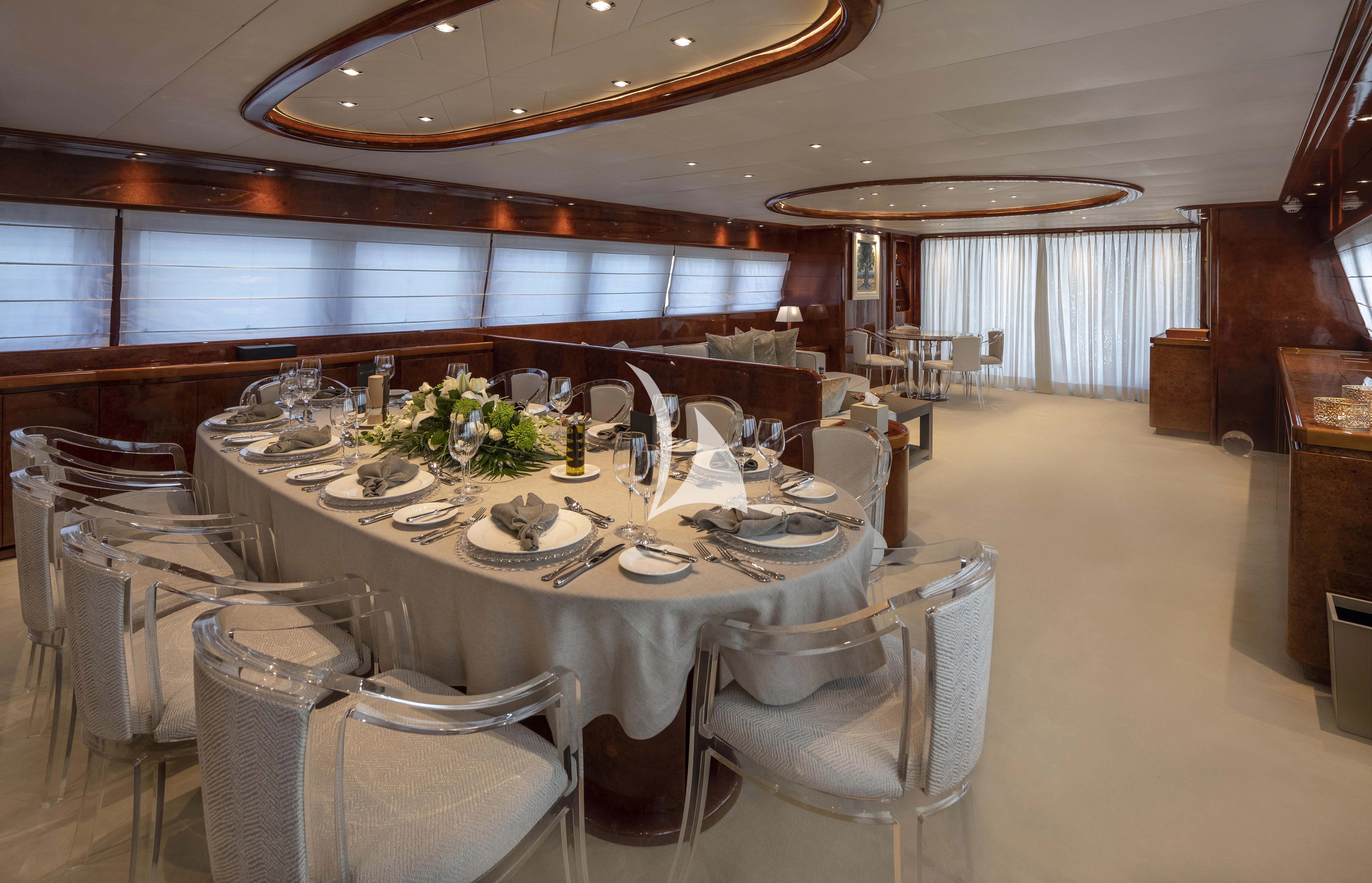 a large room with tables and chairs aboard SOLE DI MARE Yacht for Sale