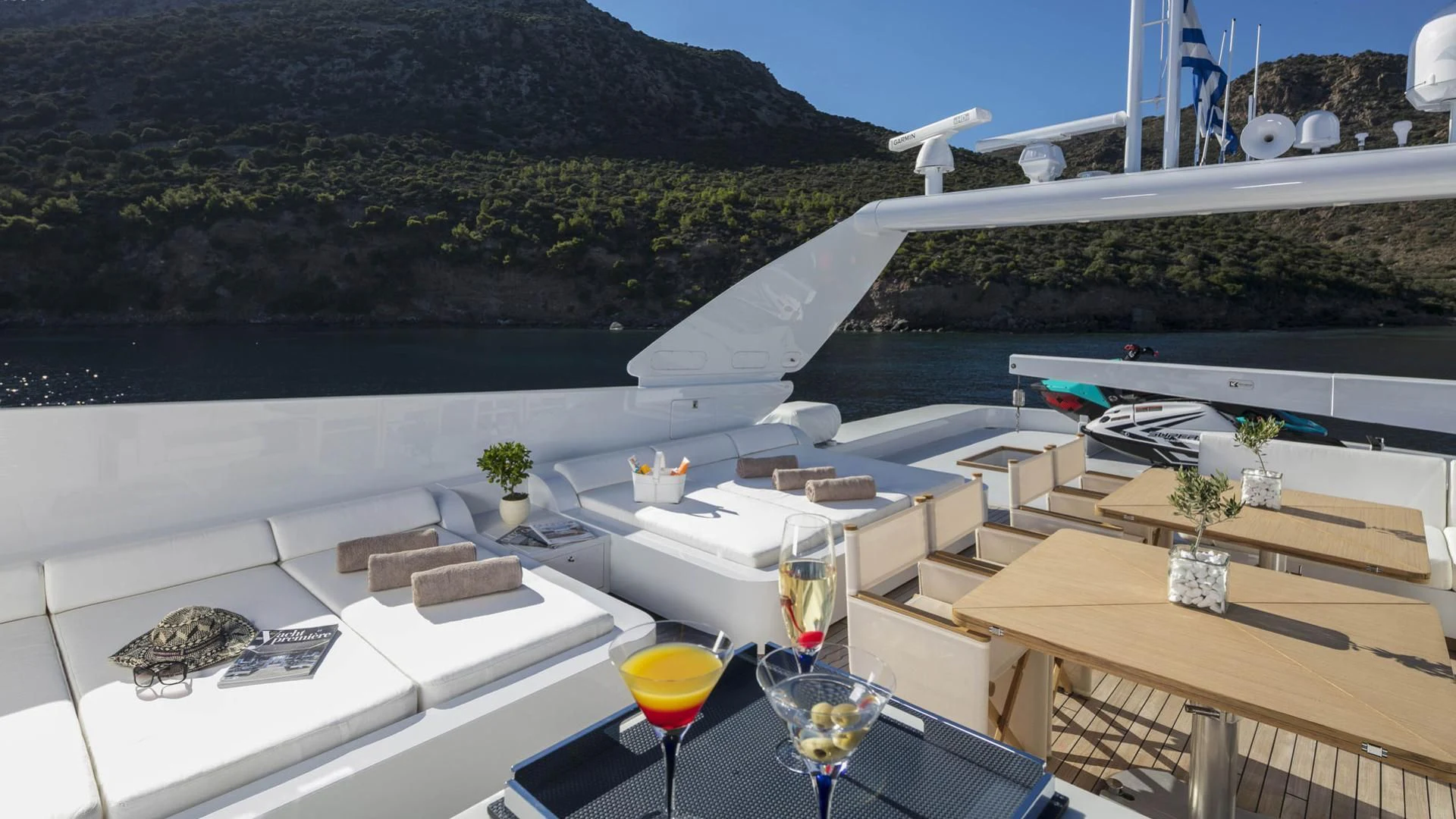 a room with a pool and a deck with a pool and mountains in the background aboard SOLE DI MARE Yacht for Sale