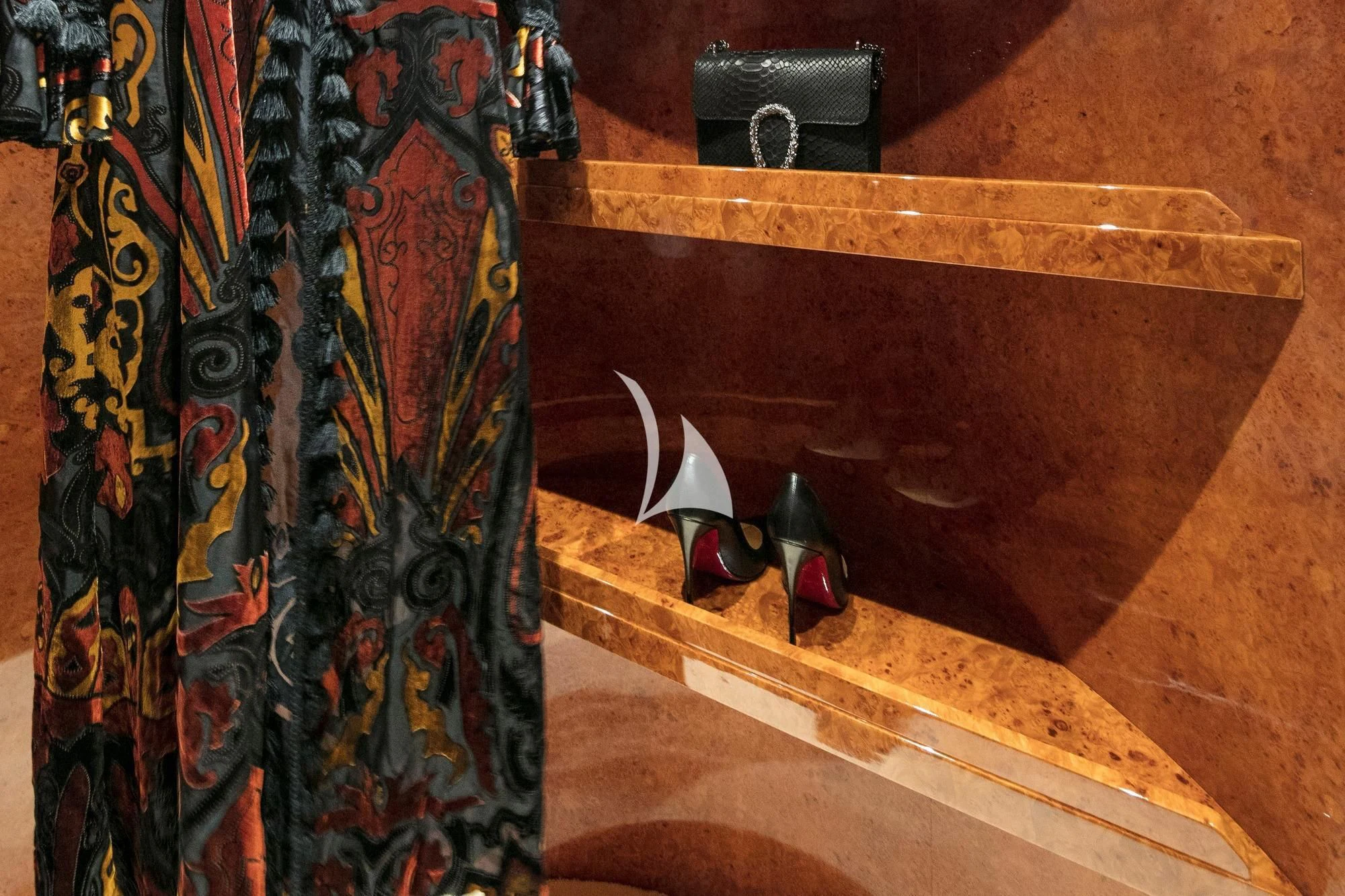 a wooden cabinet with a curtain and a vase with flowers aboard SOLE DI MARE Yacht for Sale