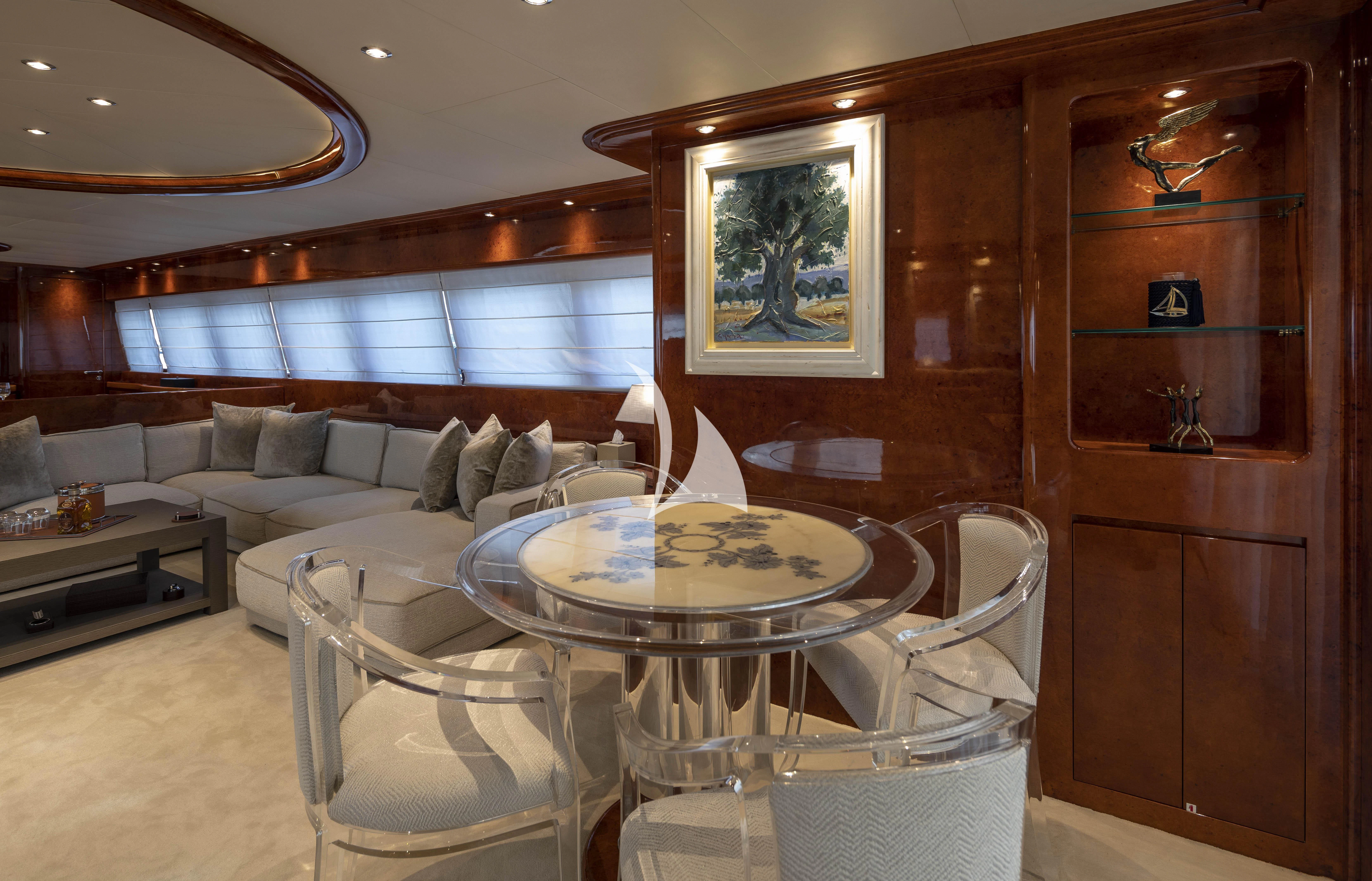 a living room with a couch and a table aboard SOLE DI MARE Yacht for Sale