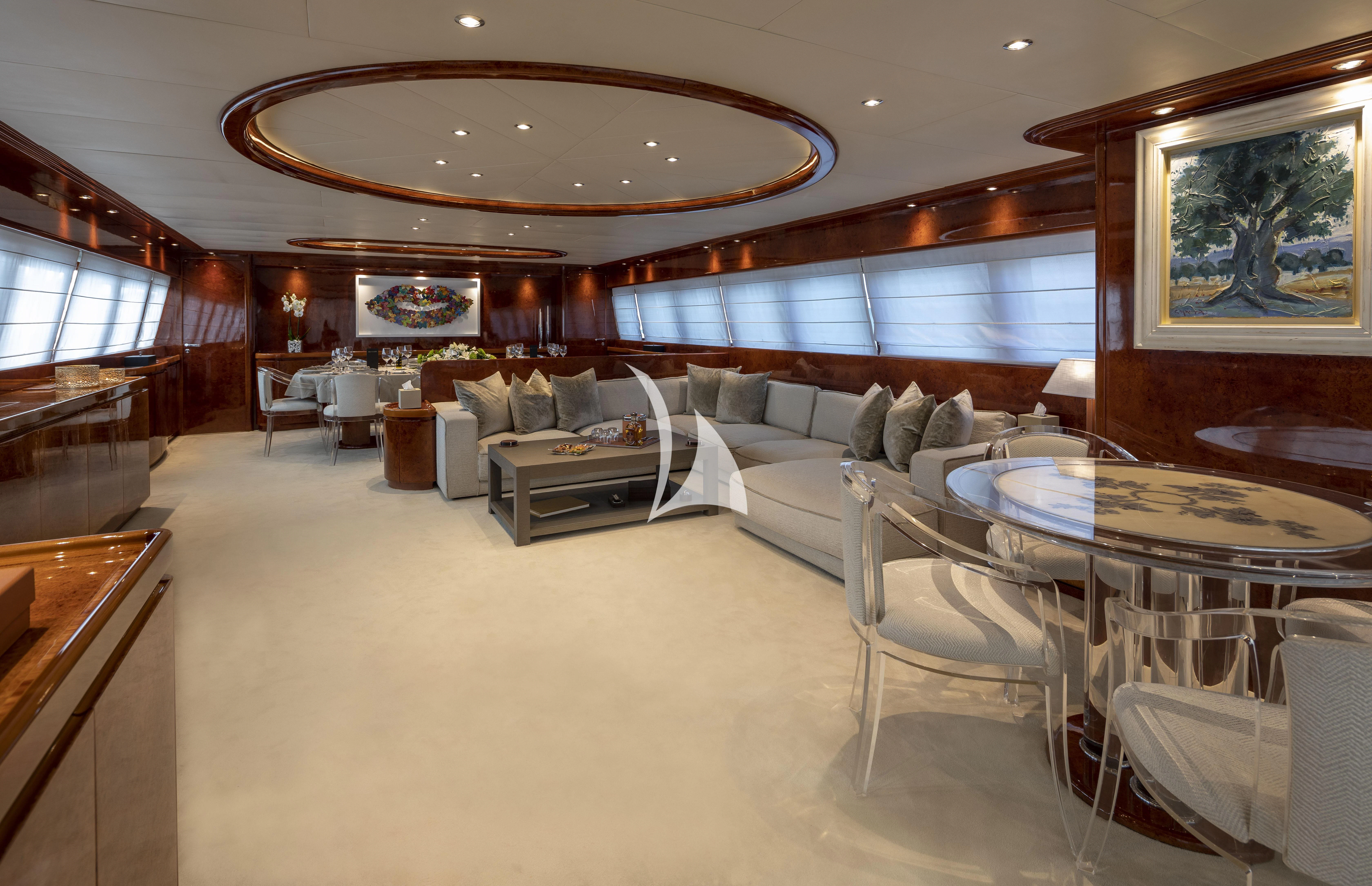 a large living room with a large chandelier aboard SOLE DI MARE Yacht for Sale