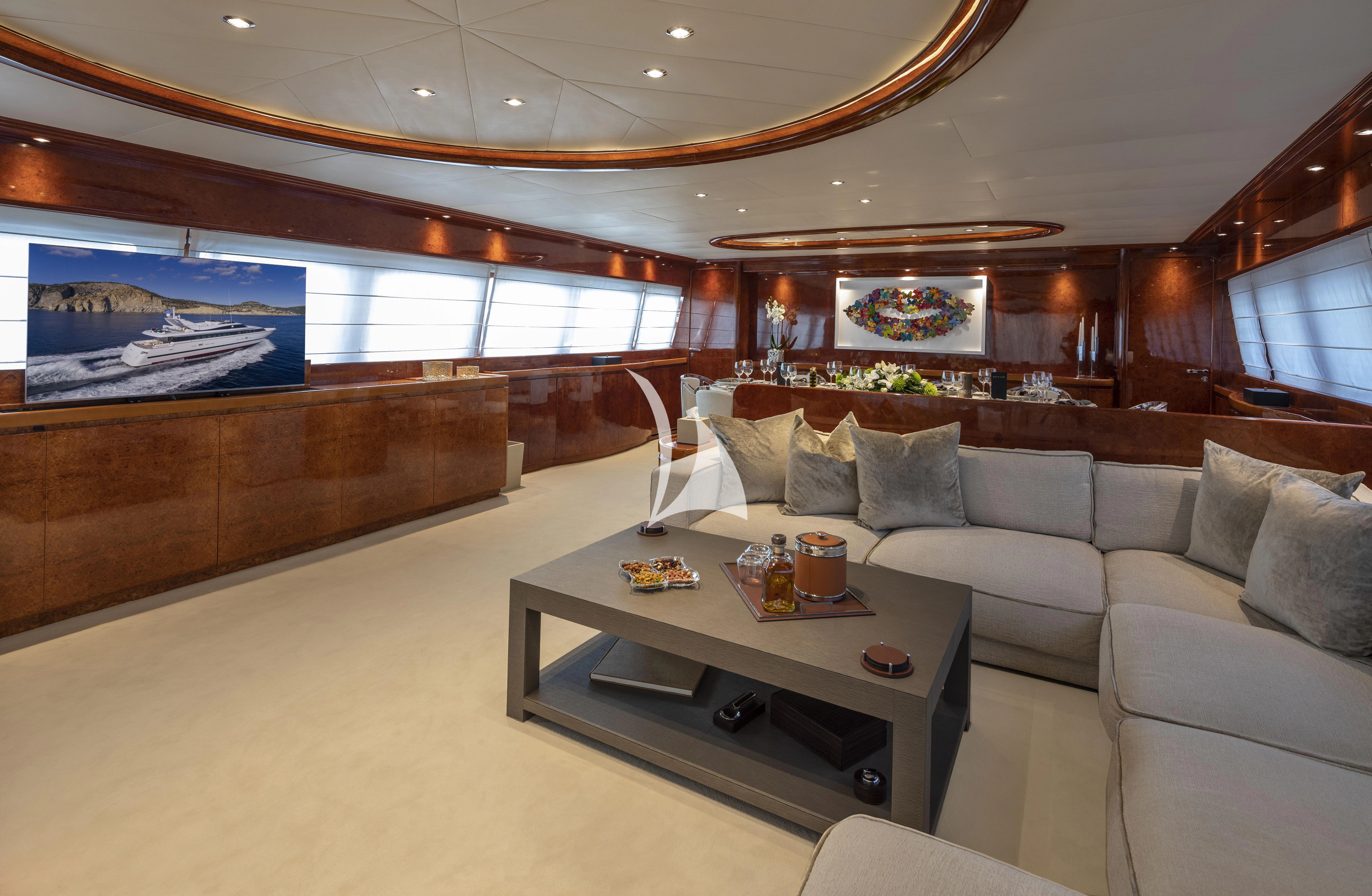 a living room with a couch and a coffee table aboard SOLE DI MARE Yacht for Sale