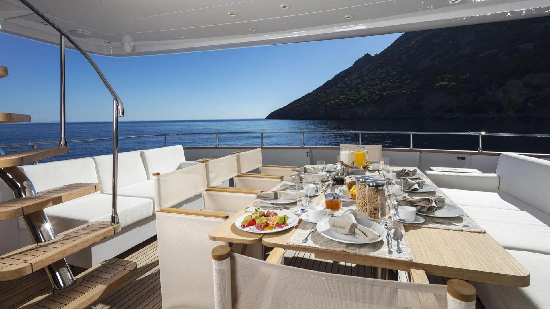 a table with plates and glasses on it aboard SOLE DI MARE Yacht for Sale
