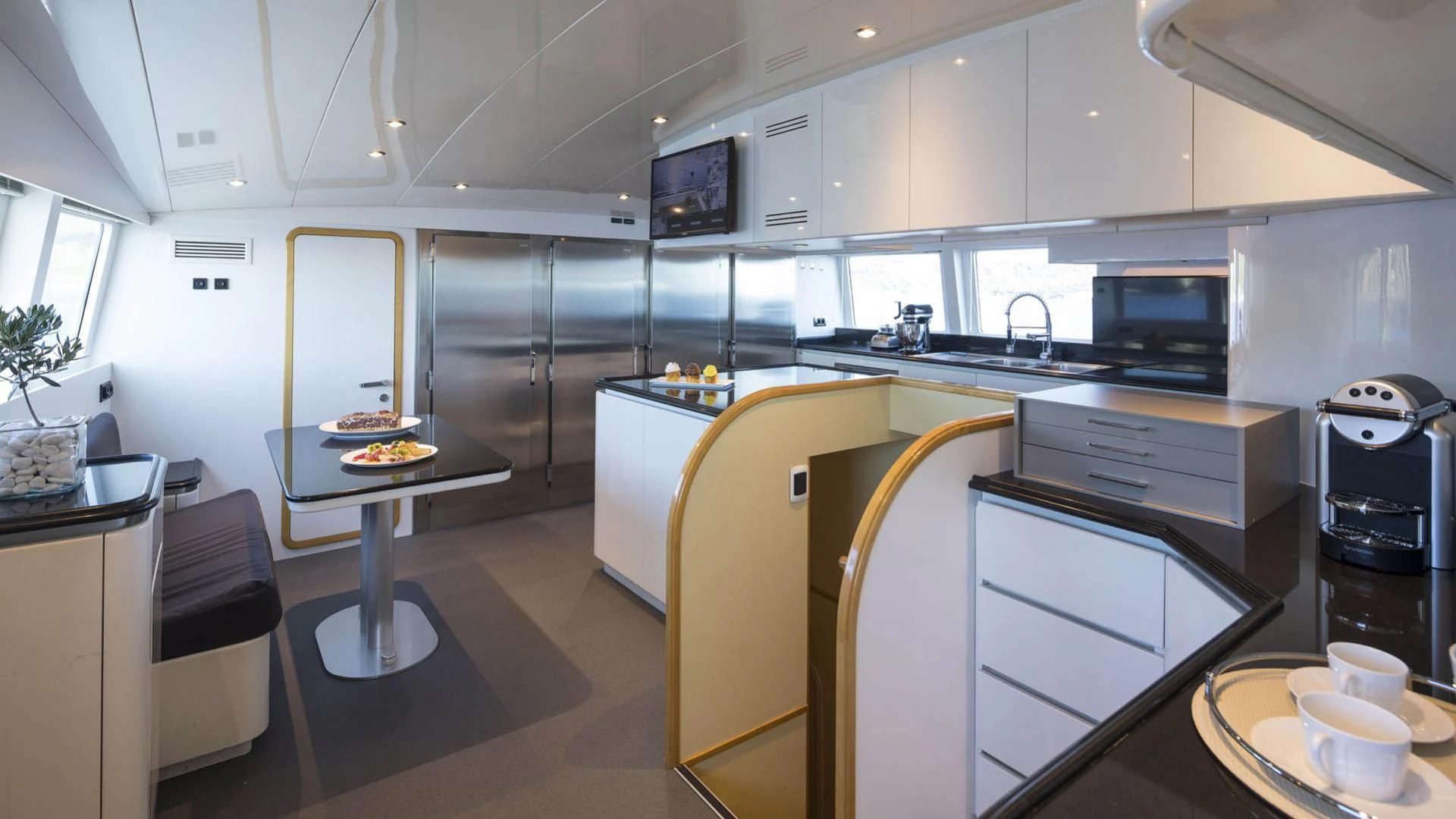 a kitchen with white cabinets aboard SOLE DI MARE Yacht for Sale
