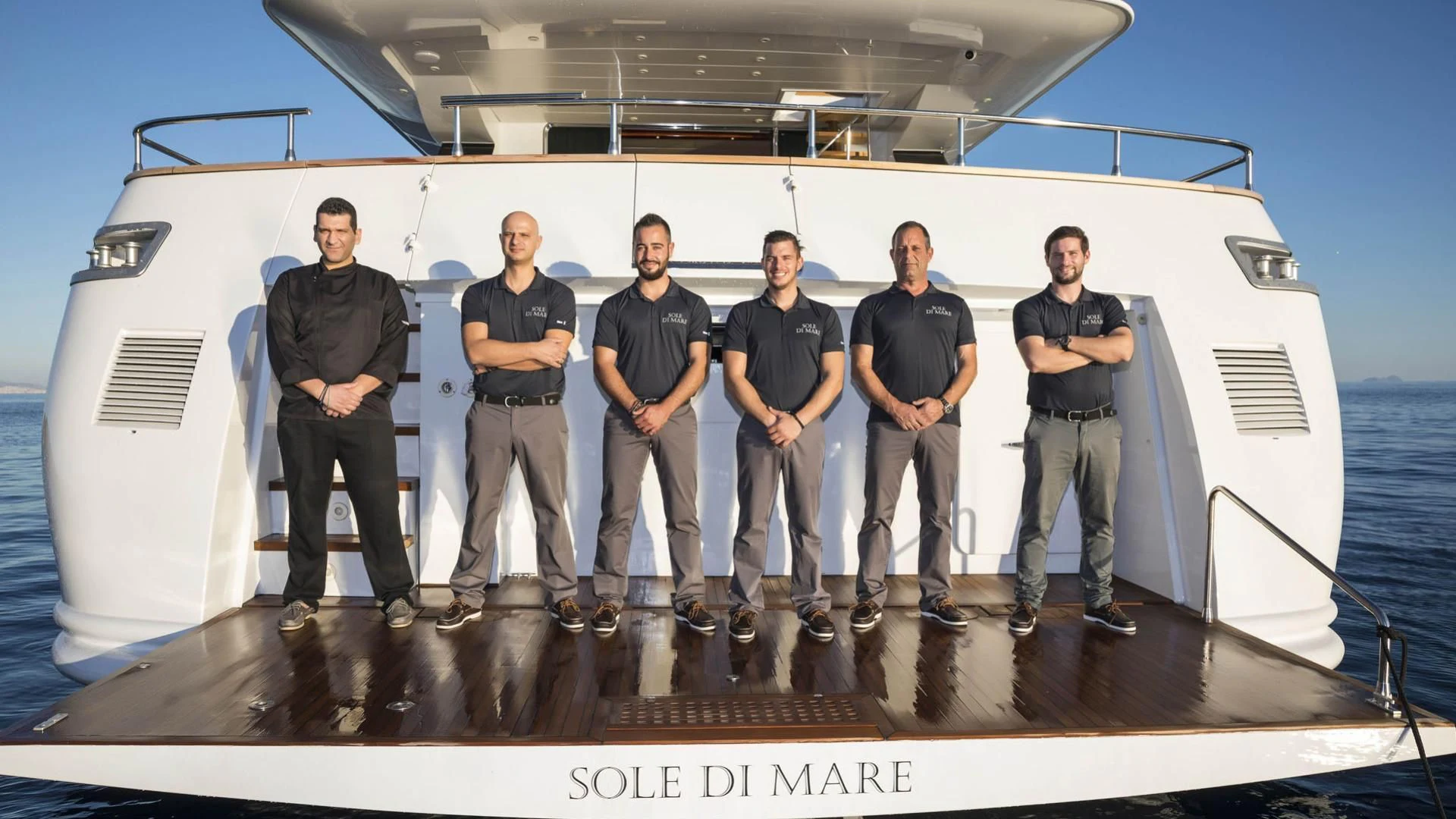 a group of people standing on a boat aboard SOLE DI MARE Yacht for Sale