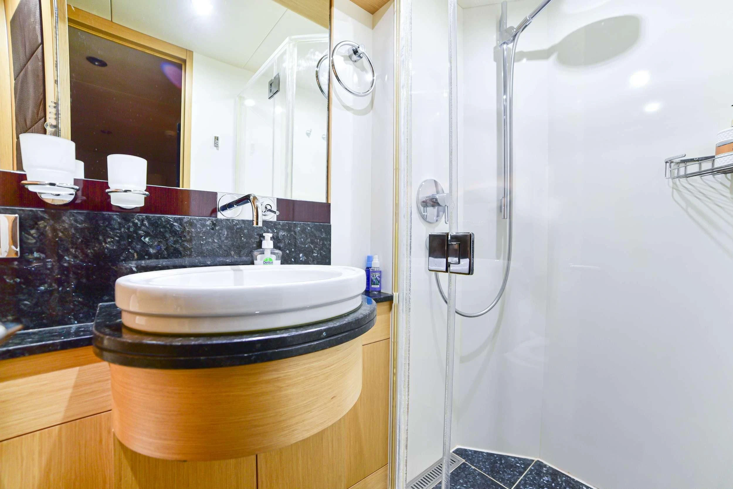 a bathroom with a sink and a mirror aboard STELA 117 Yacht for Sale