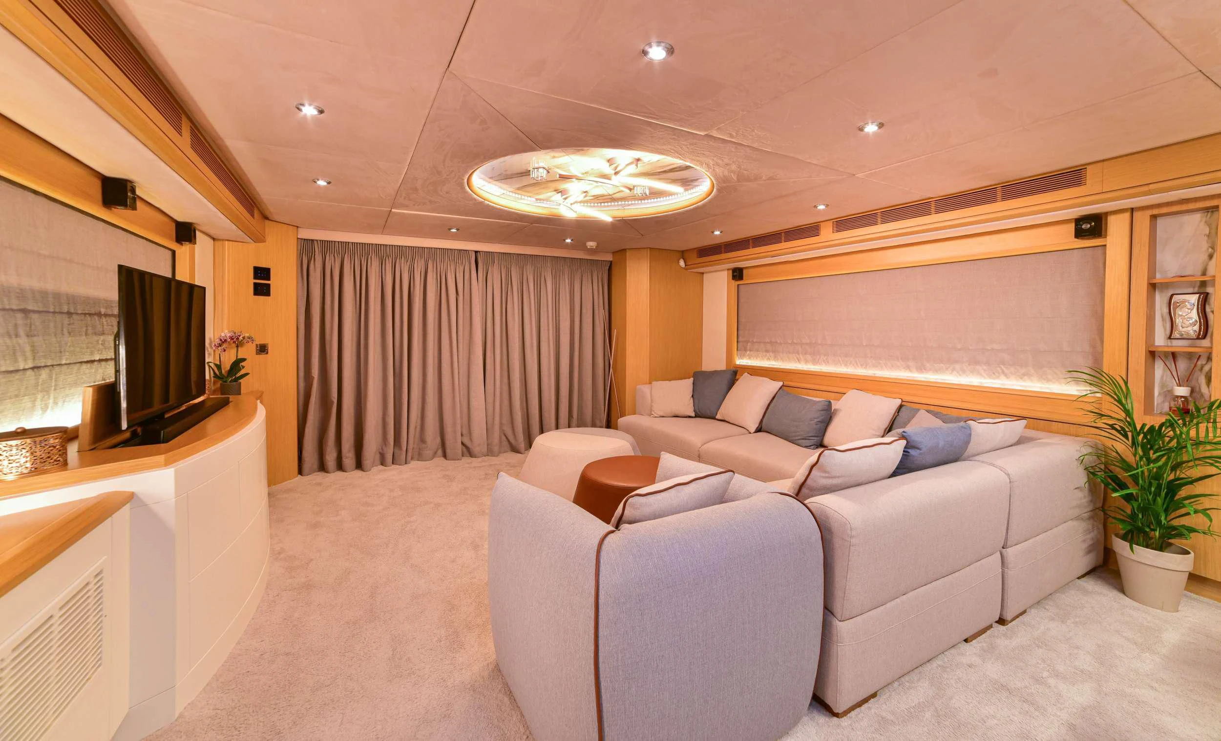 a living room with a couch and a television aboard STELA 117 Yacht for Sale