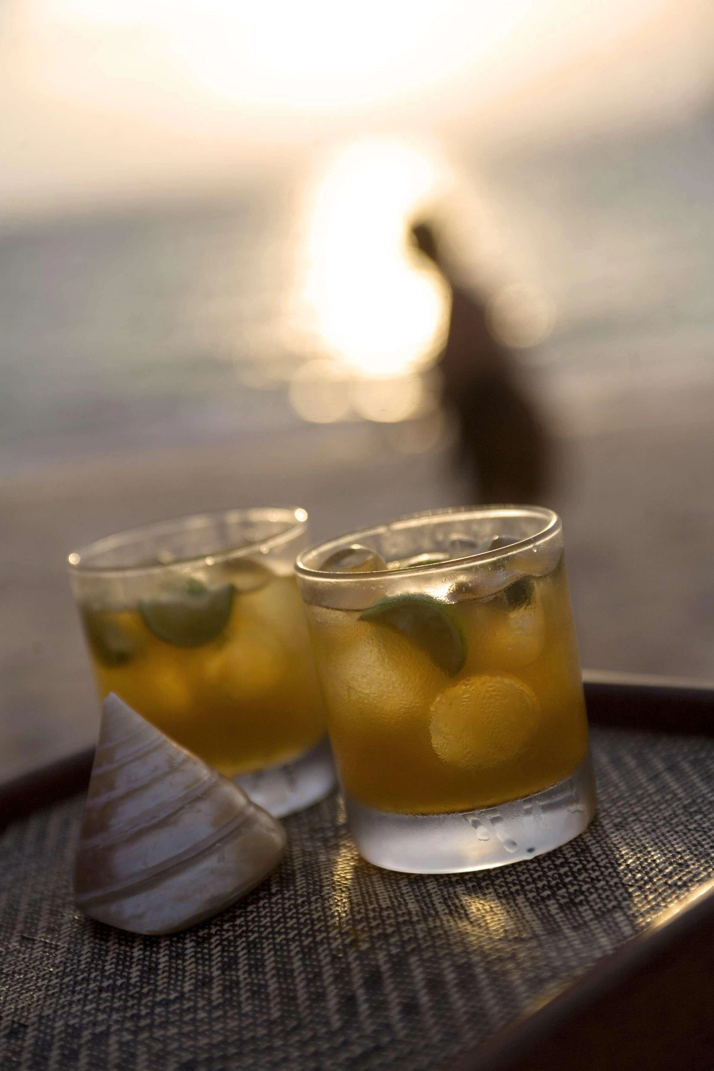 a couple of glasses of yellow liquid on a table aboard SILOLONA Yacht for Sale