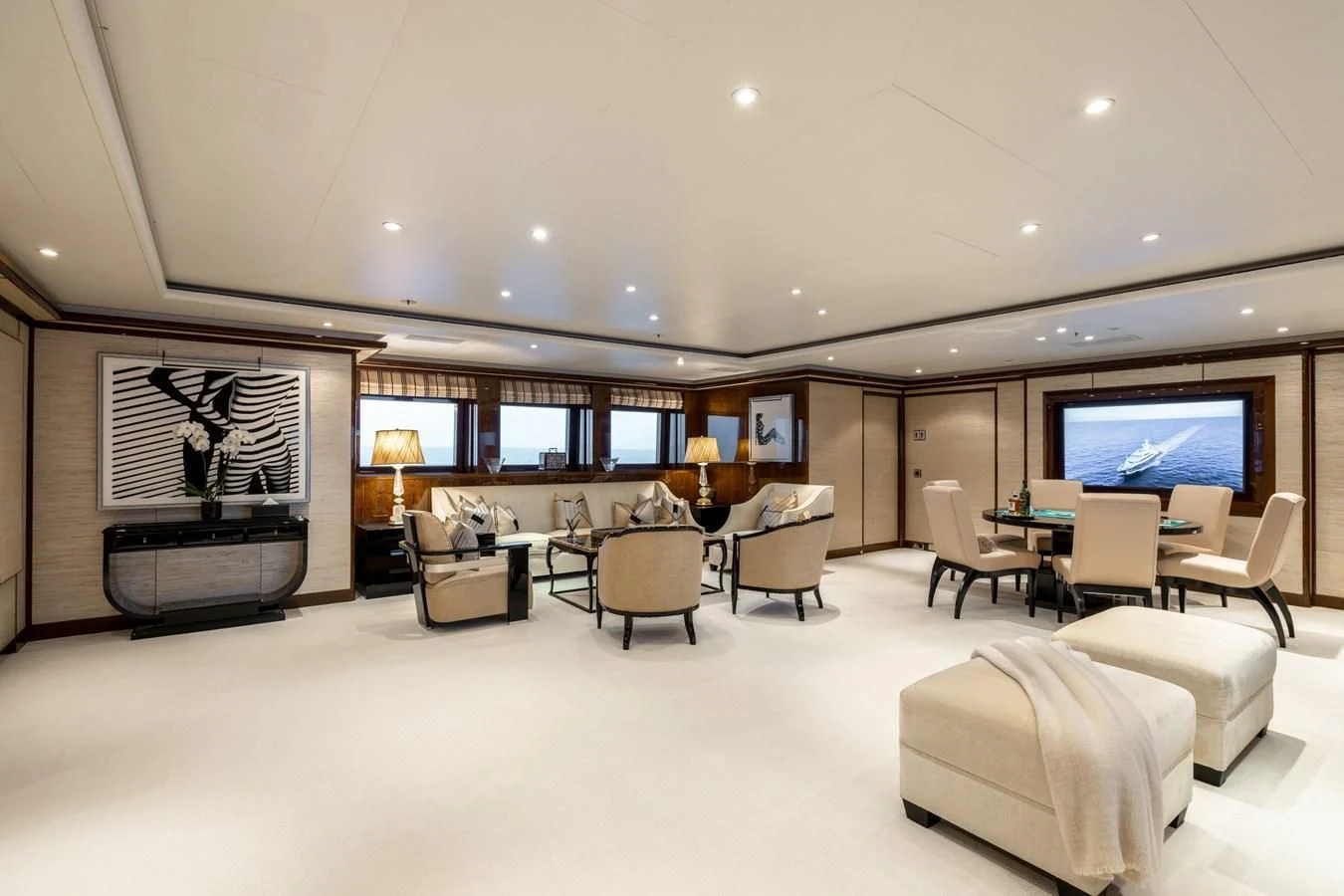a large room with a table and chairs and a tv aboard BATELLO Yacht for Sale
