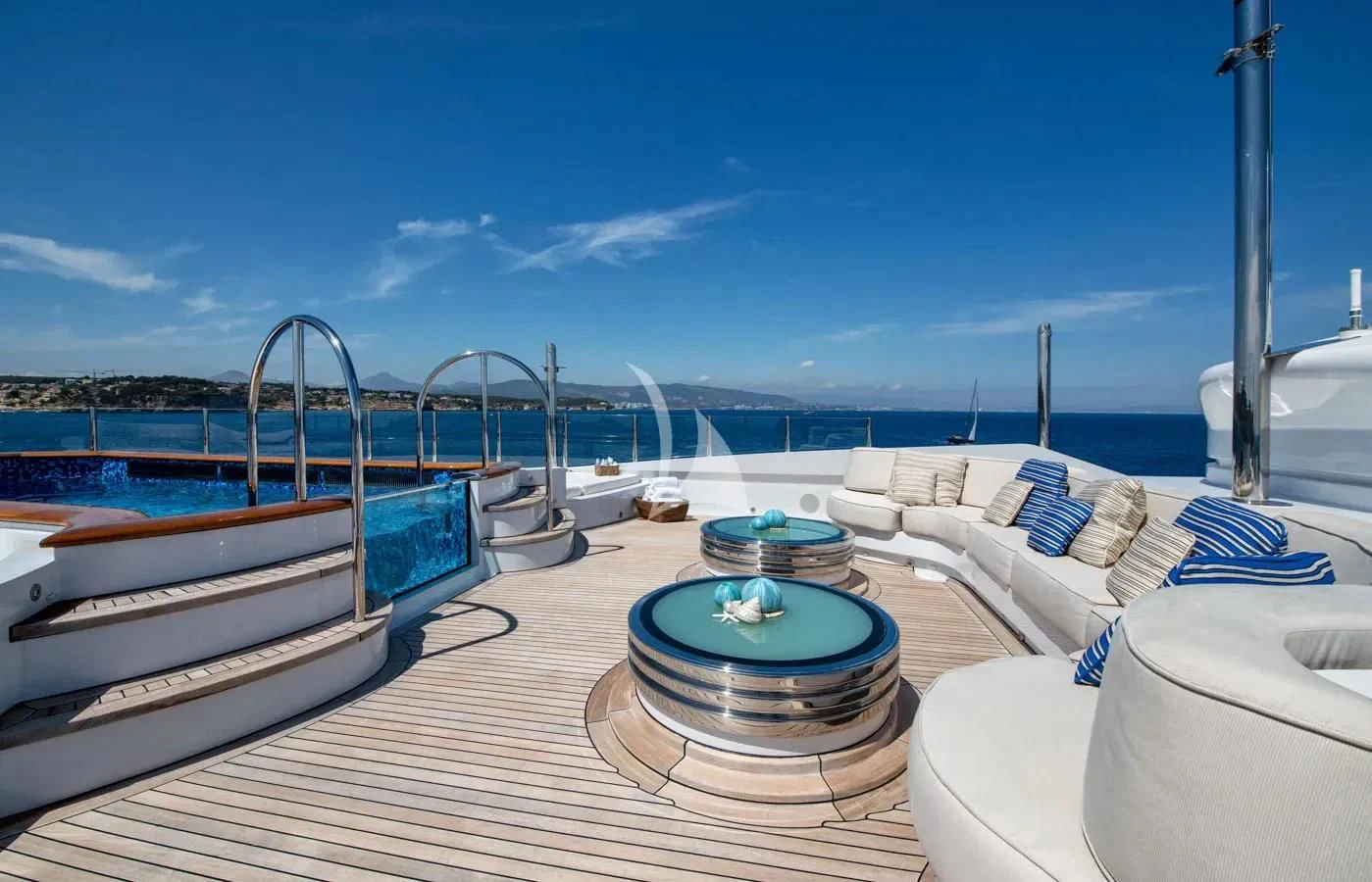 a deck with a pool and a view of the water aboard BATELLO Yacht for Sale
