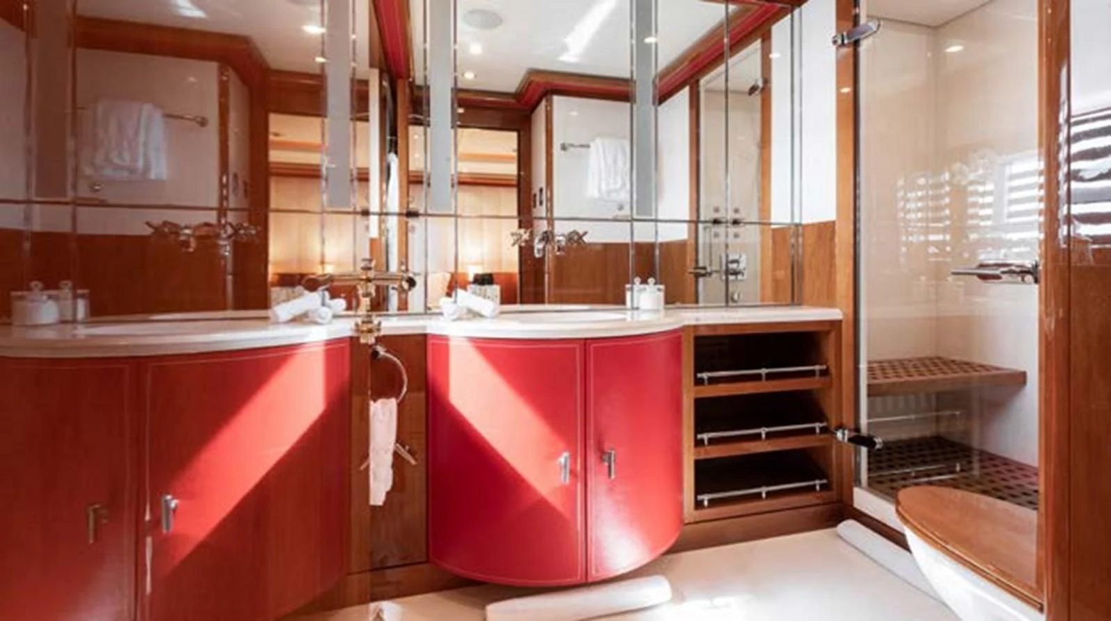 a kitchen with red cabinets aboard BATELLO Yacht for Sale